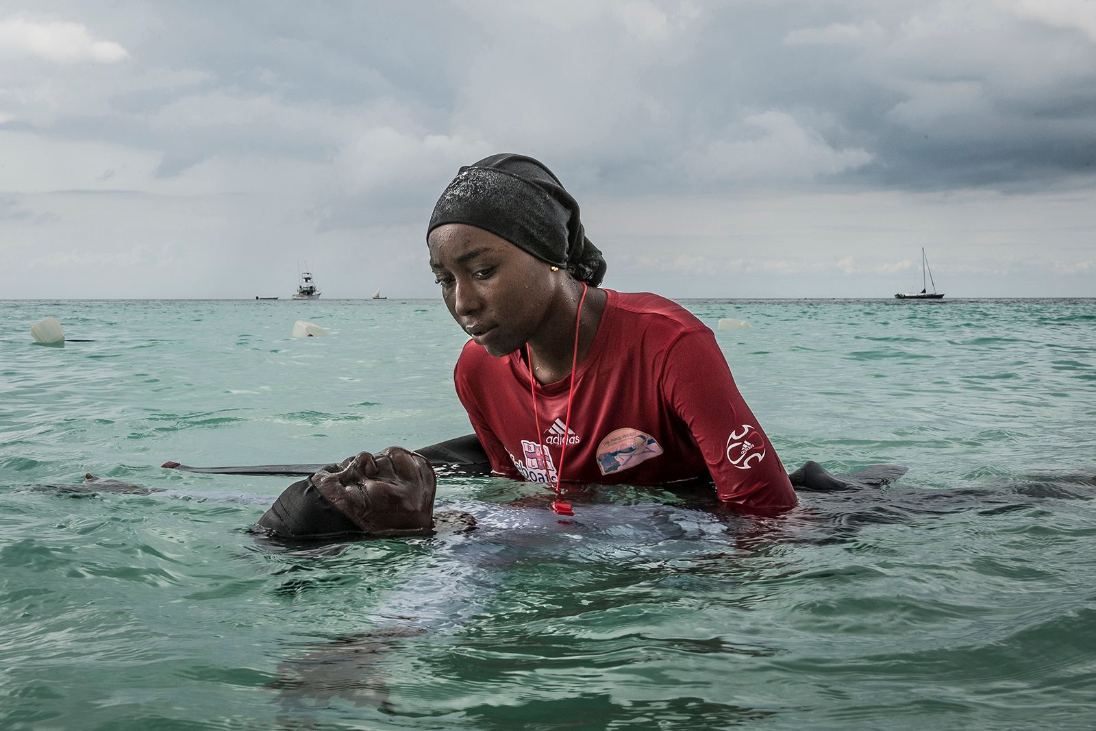 © Anna Boyiazis - Swim instructor Siti, 24, helps a girl float in the Indian Ocean off of Nungwi, Zanzibar.