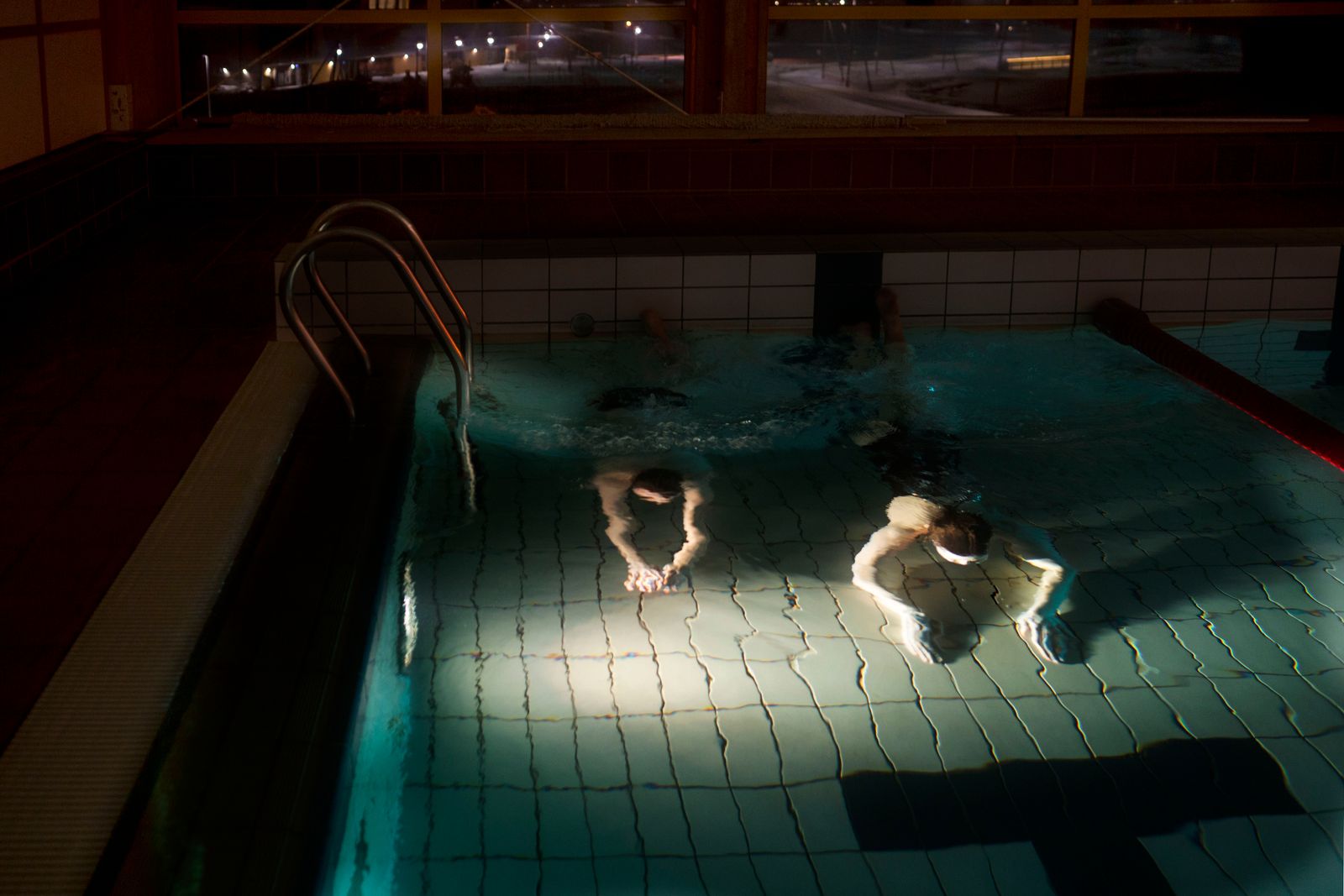 © Axelle de Russé - Two young students from the Longyearbyen University of Science enjoy this swimming pool after school. February 2019, 7 pm.