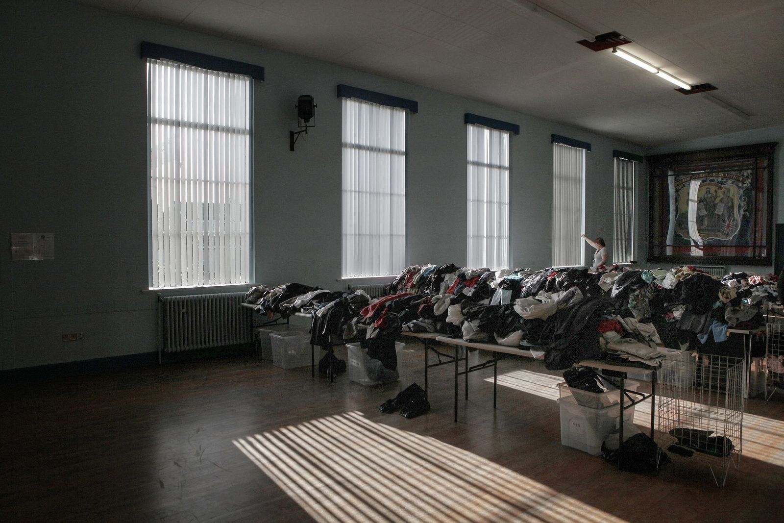© Mary Turner - Clothes are laid out on tables at a clothing bank for those in need to come and collect at a Miner's Welfare Club in Durham.
