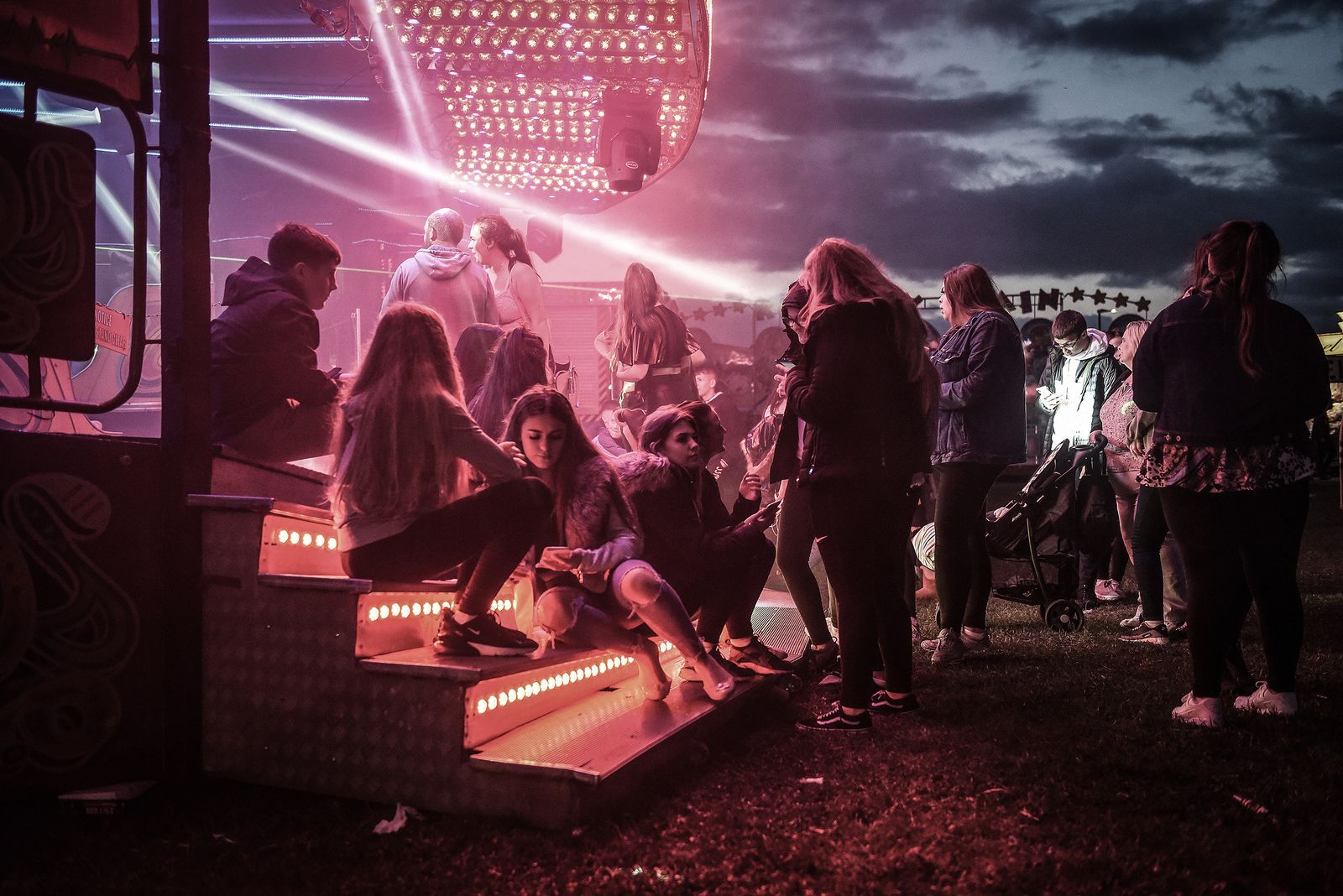 © Mary Turner - Teenagers sit on the rides as the fair comes to town in Hartlepool