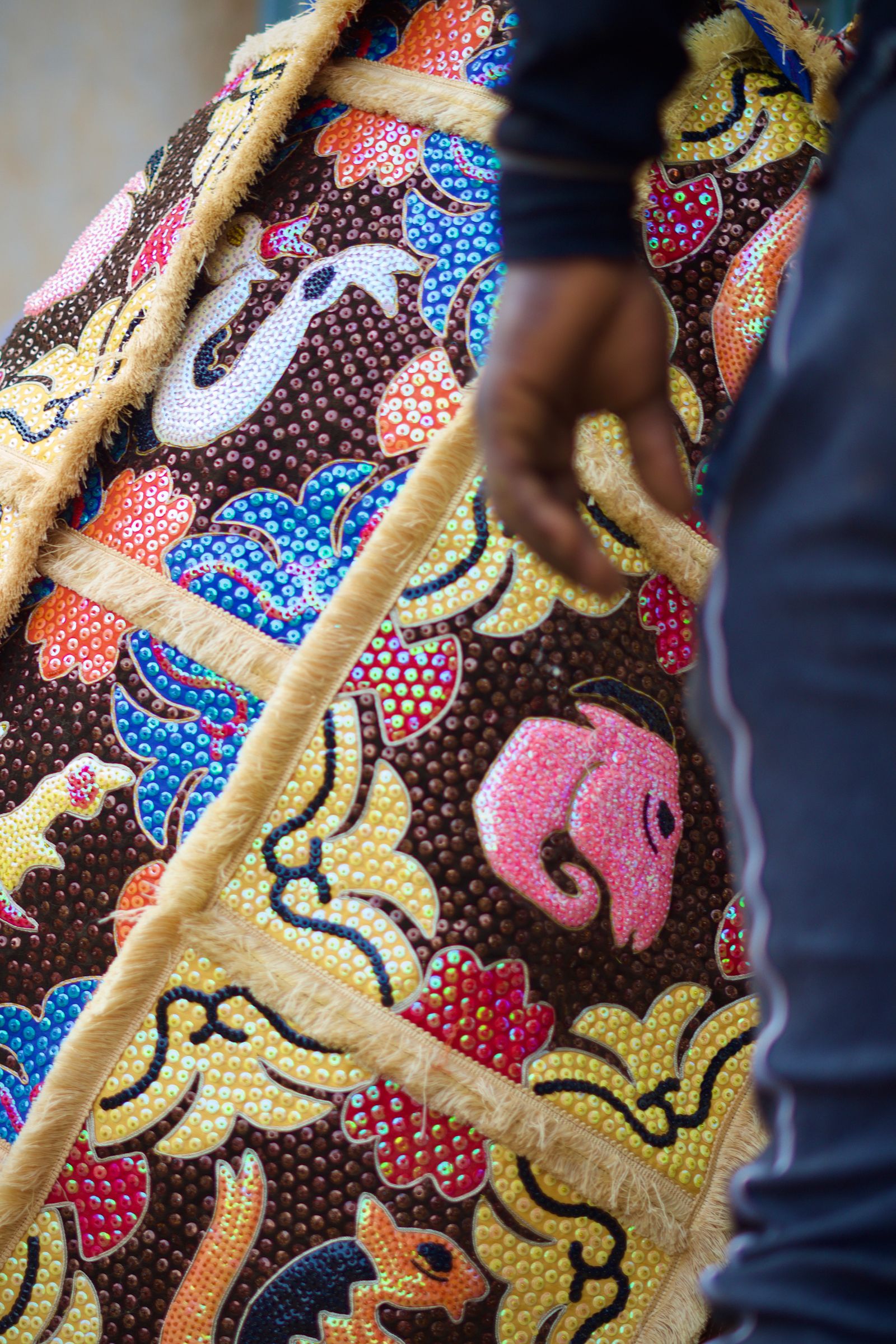 © Paola Chapdelaine - Detail of a revenant habit, made of complex and colorful embroideries.