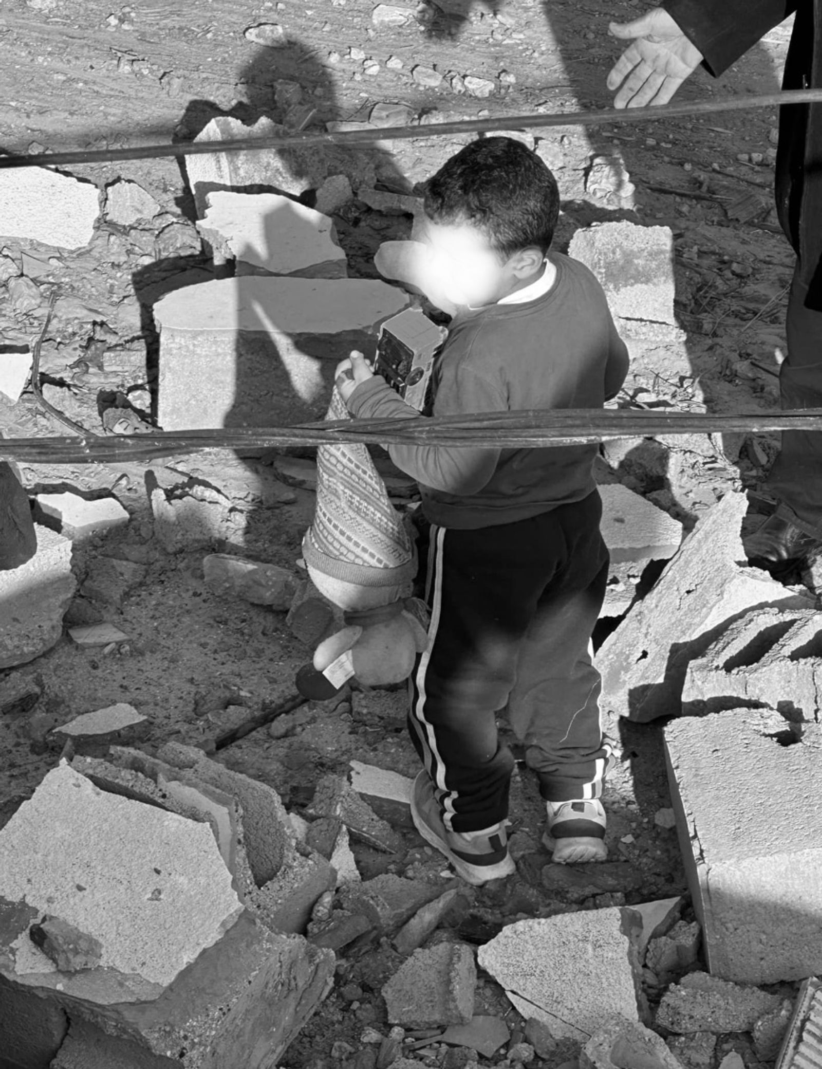 © Glorianna Ximendaz - The son of my closest friends picking up his toys after their home was bombed. He was trapped under the rubble for hours.