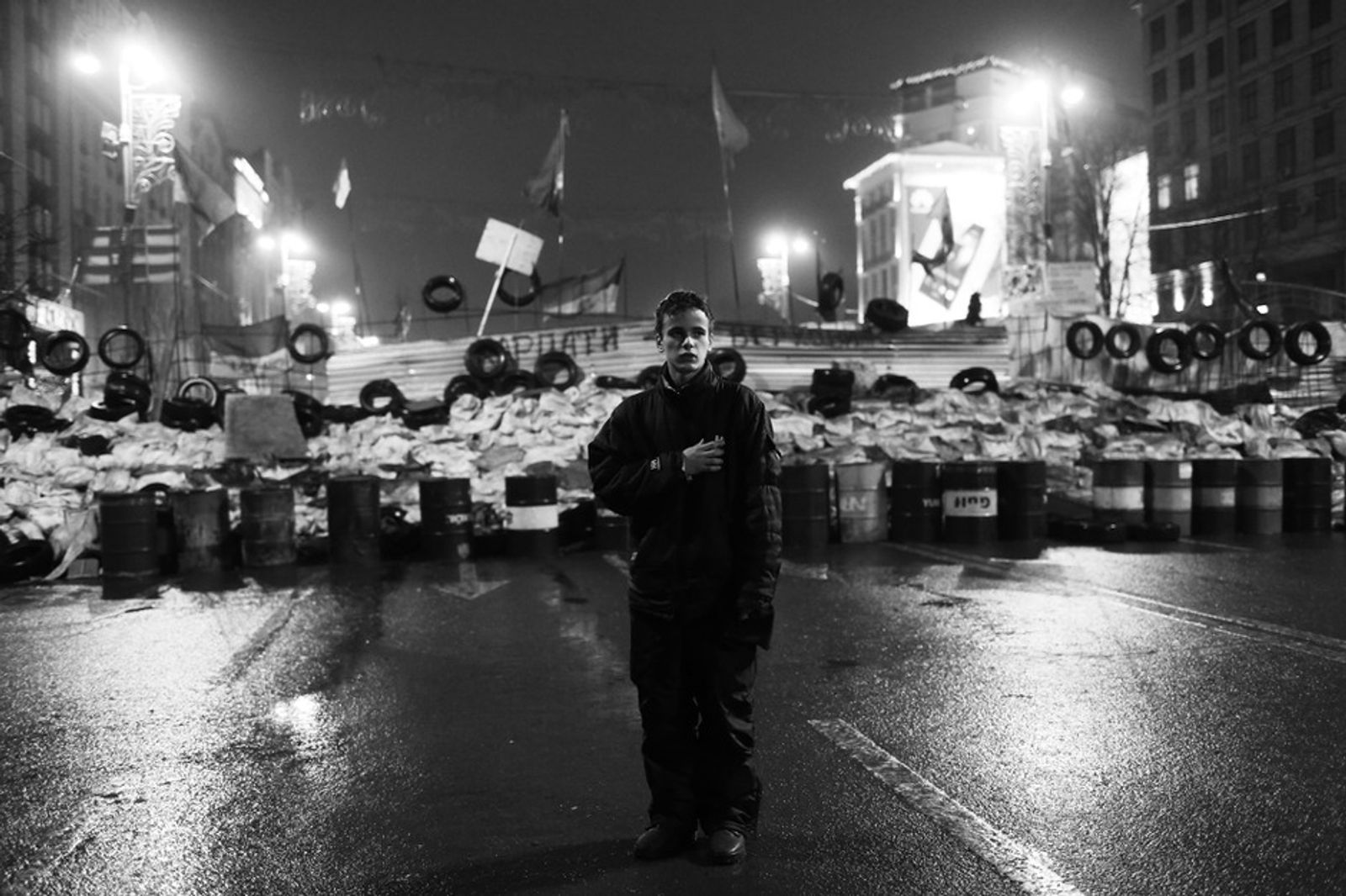© Dina Oganova - One of the night in the EuroMaidan,boy are standing and singing the Ukrainian hymn