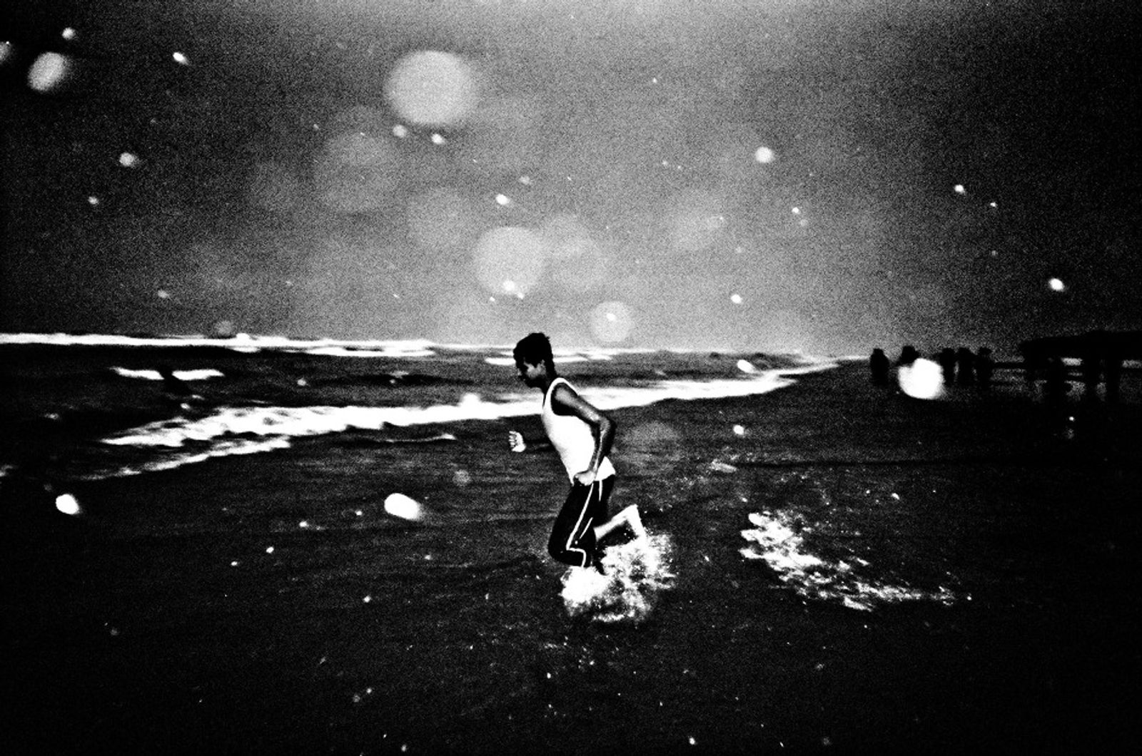© K. M. Asad - A boy run to swim in the rainy day.