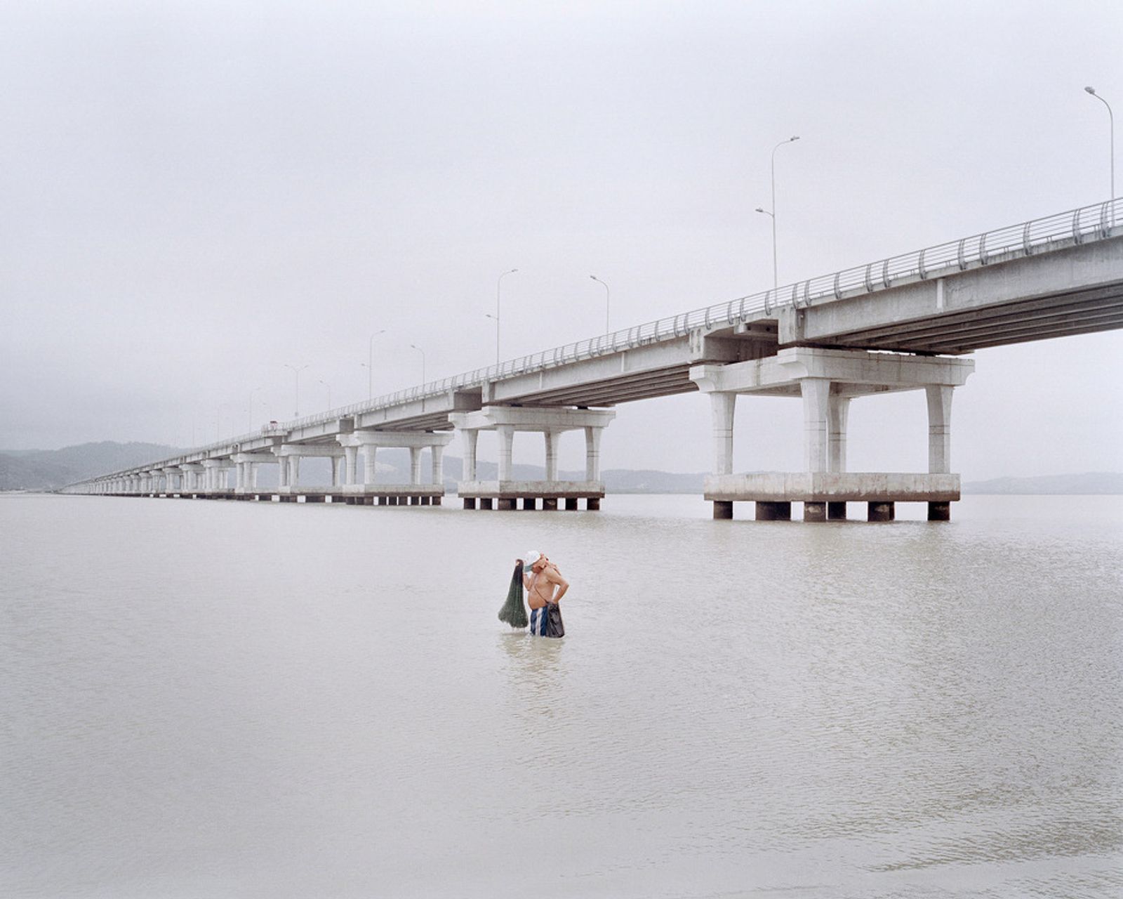 © Pietro Paolini - A shrimp fisherman under the new bridge built by the government of the Bay of Caraquez. October 2012