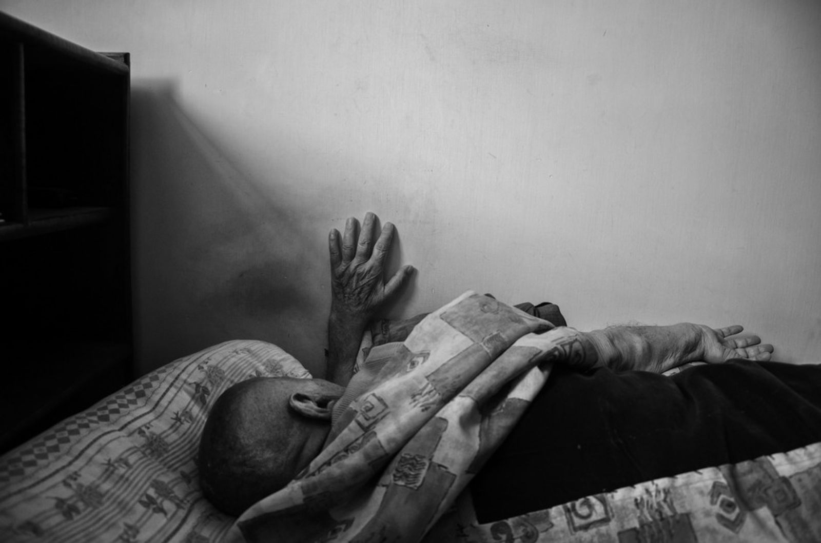 © Khashayar Sharifaee - Grandfather is asleep on his bed.
