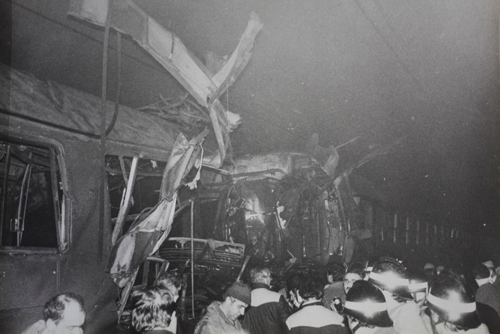 © Martino Lombezzi - FS Italian railway archives. December 23th, 1984. Rescuers around the destroyed train car inside the tunnel.