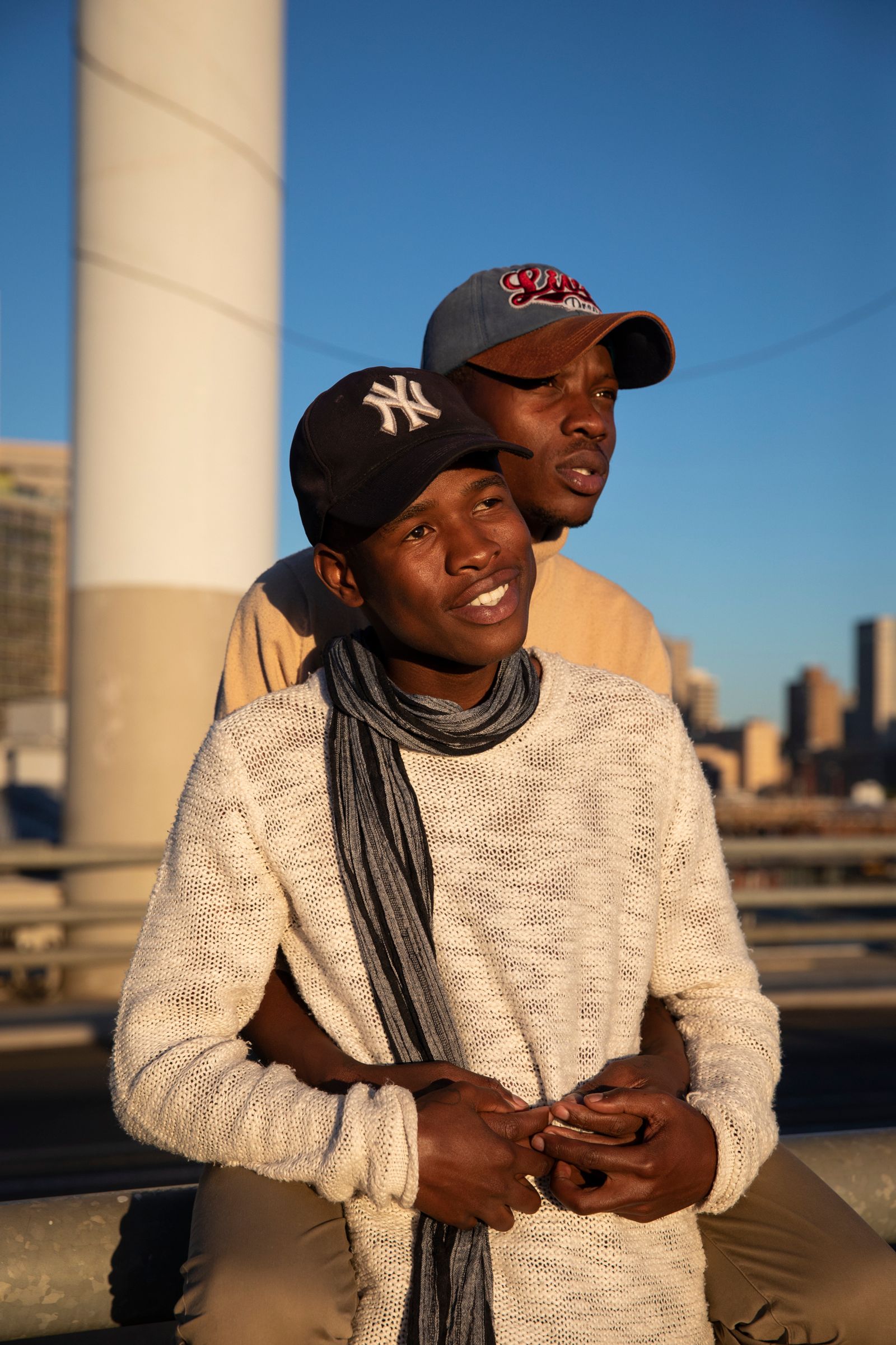 © Ilvy Njiokiktjien - Ofentse (26) together with his boyfriend Lewis (21) on the Nelson Mandela bridge in Johannesburg, South Africa.