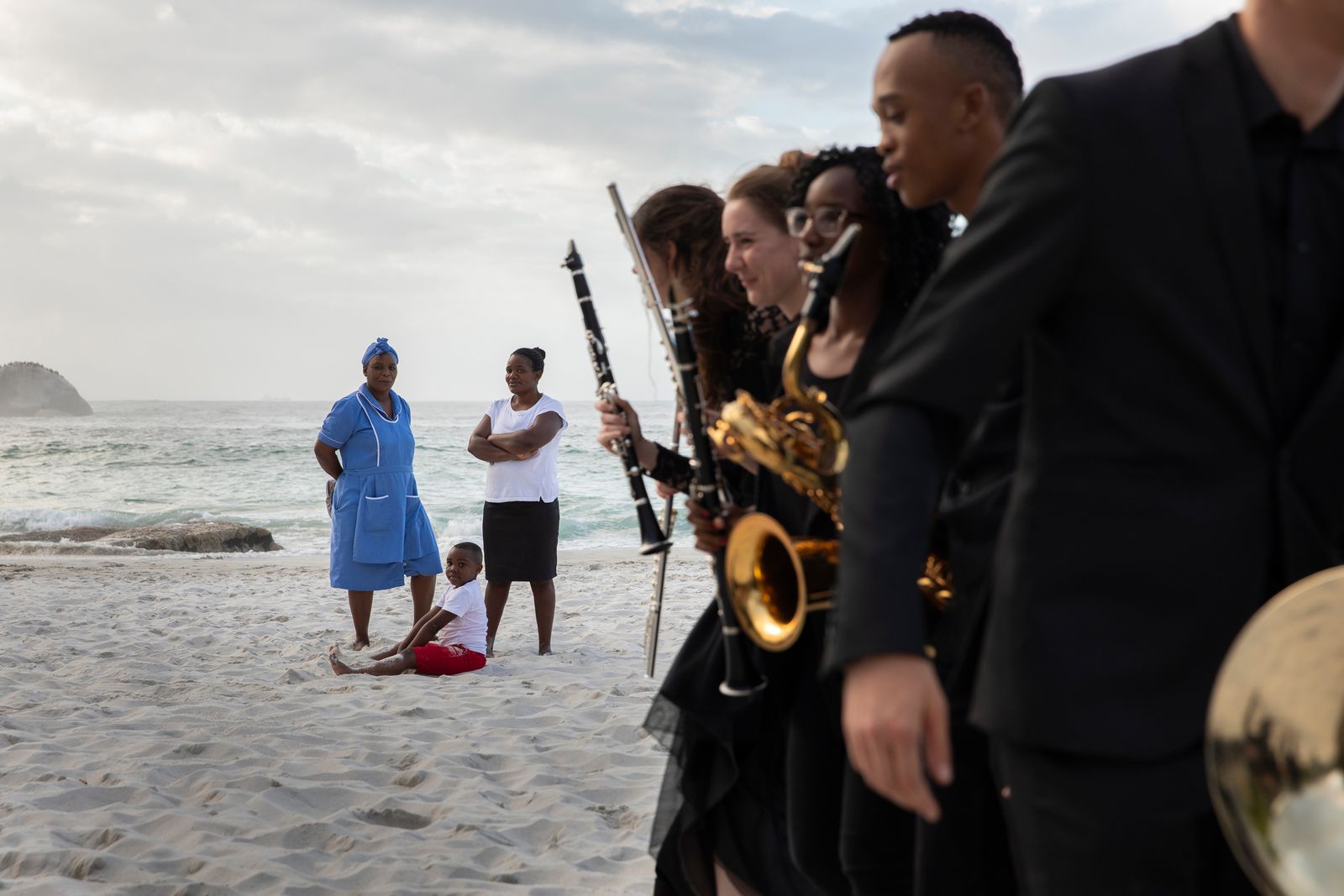 © Ilvy Njiokiktjien - The South African National Youth Orchestra walk away after they have performed on the beach in South Africa.