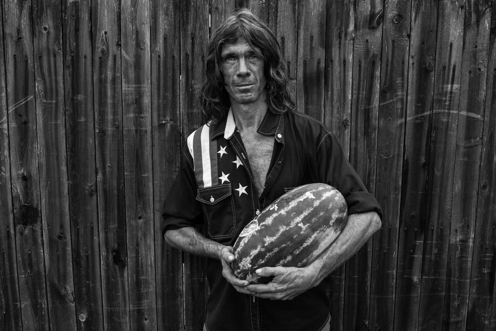 © Richard Sharum - A man holds a watermelon given to him by a local food bank. 2018.