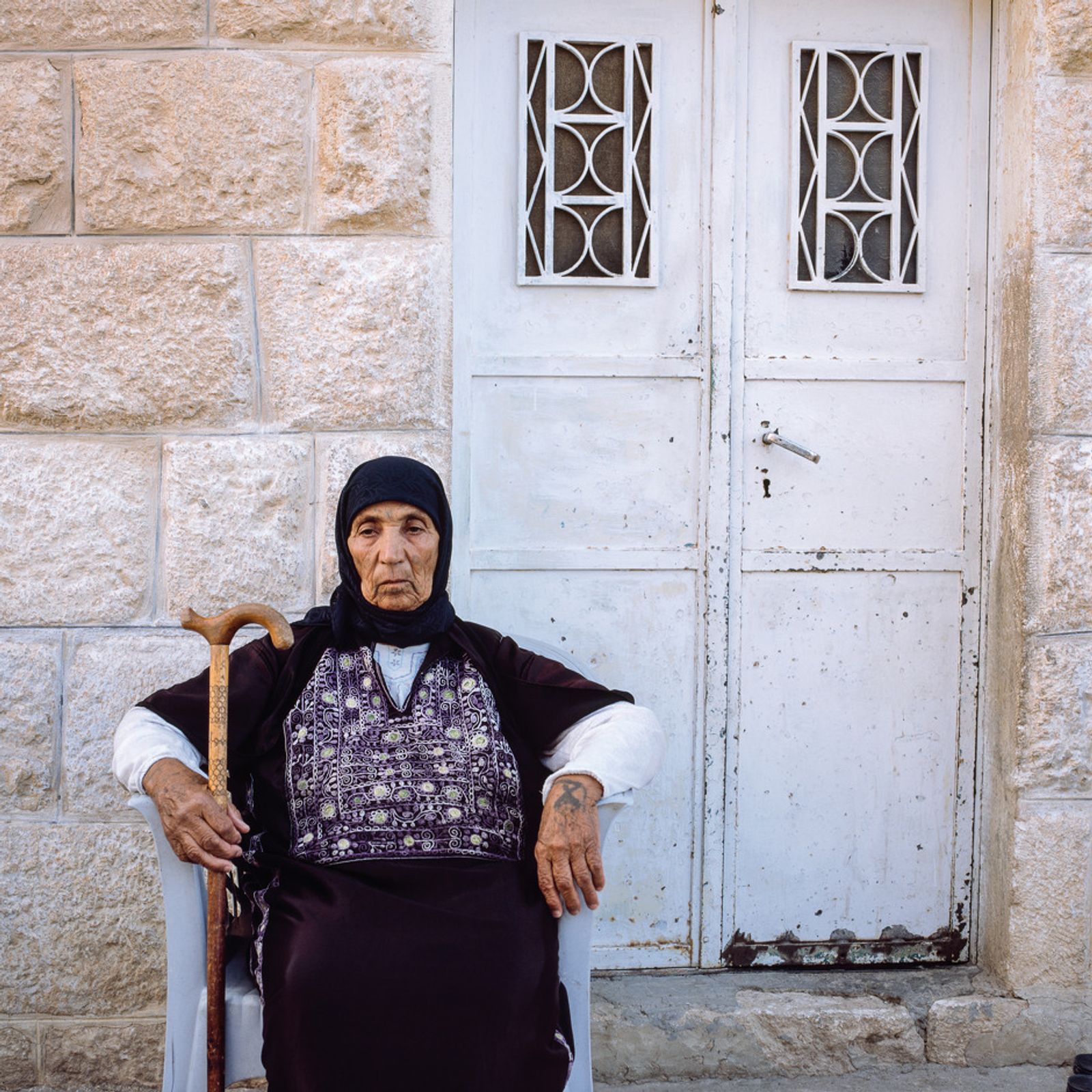 © Federico Busonero - Palestinian in front of her house, Al-Nu’man, Palestine.