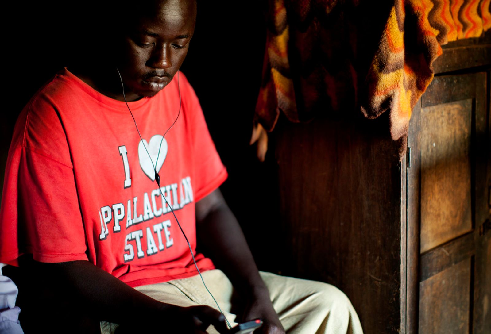 © Anne Ackermann - Listening music in his hut. There is a lot of time to kill especially for young people, the unemployment rate is very high.