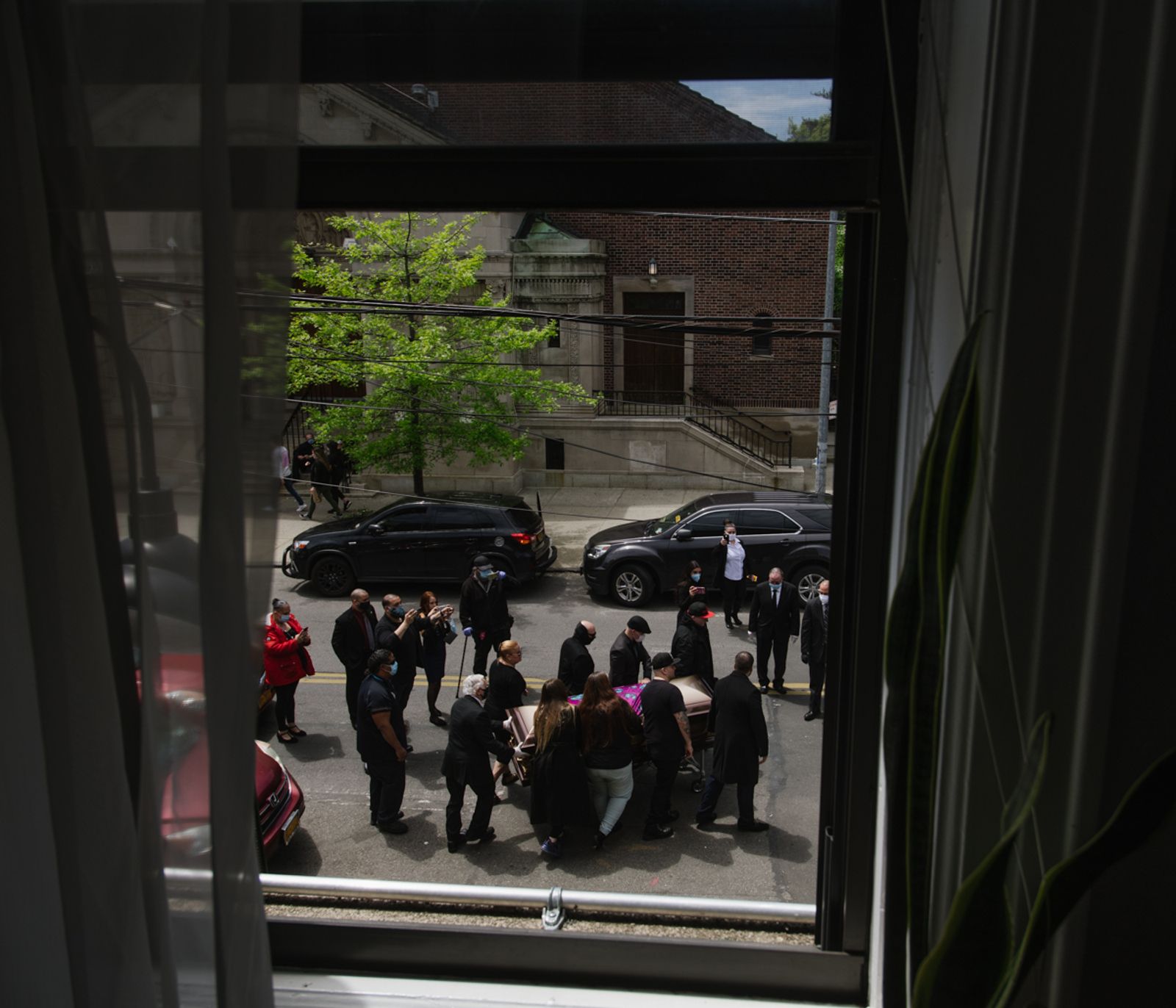 © Gili Benita - A funeral held in the street out side of the window from the apartment, Ridgewood, NYC, May 14th 2020.