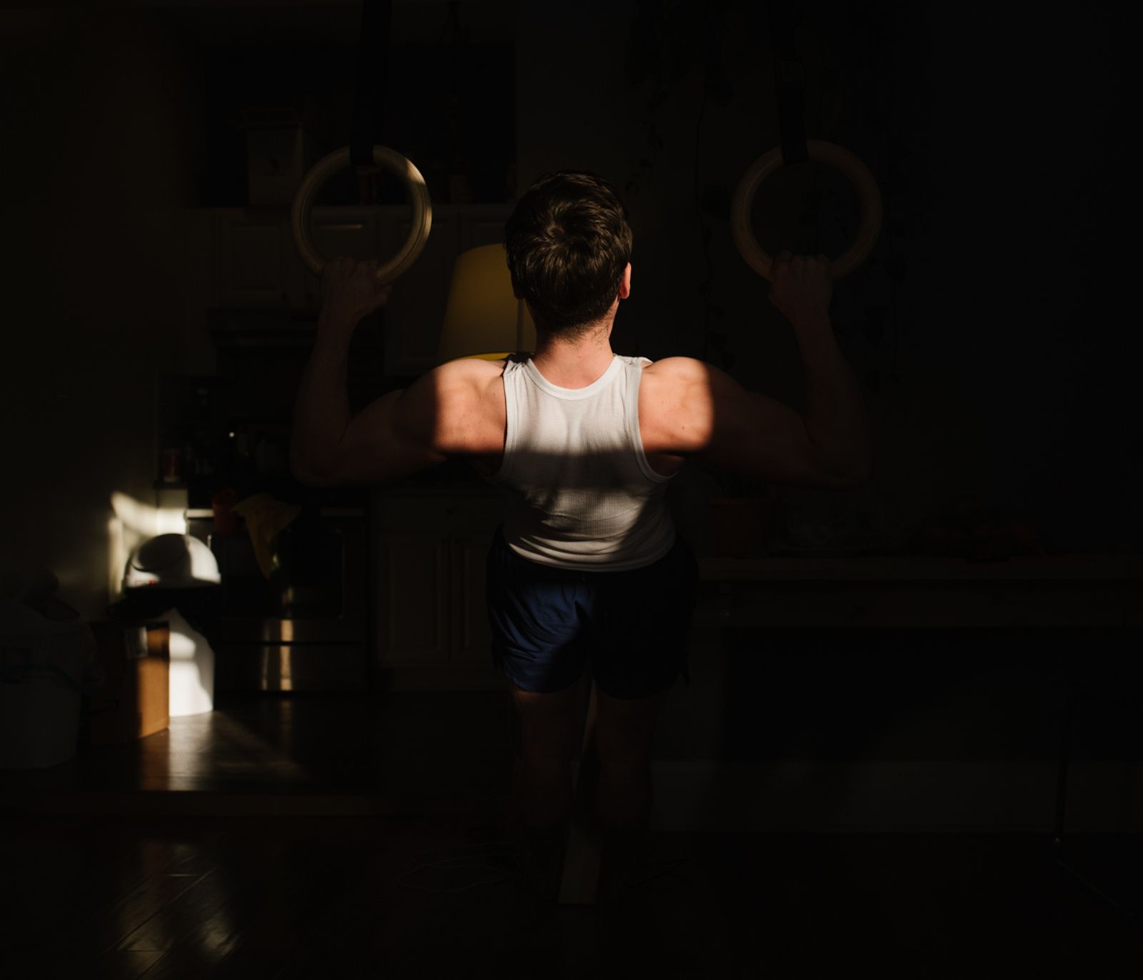 © Gili Benita - Sam (24) works out at the living room inside the Ridgewood apartment, NYC, April 21st, 2020.