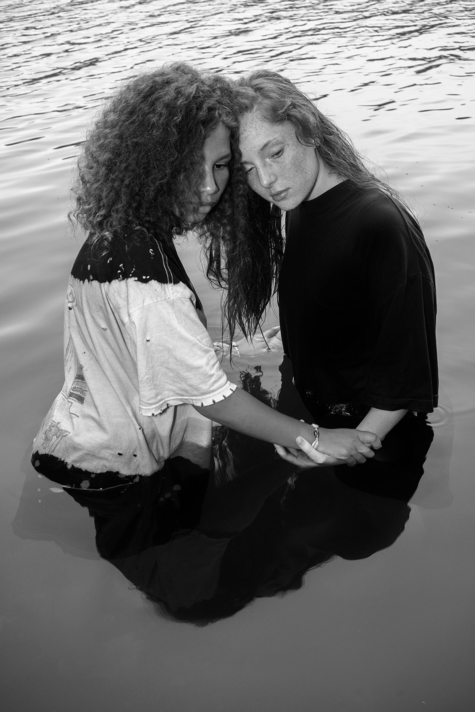© Jillian Freyer - Aiyanna and Elizabeth embrace one another in the river