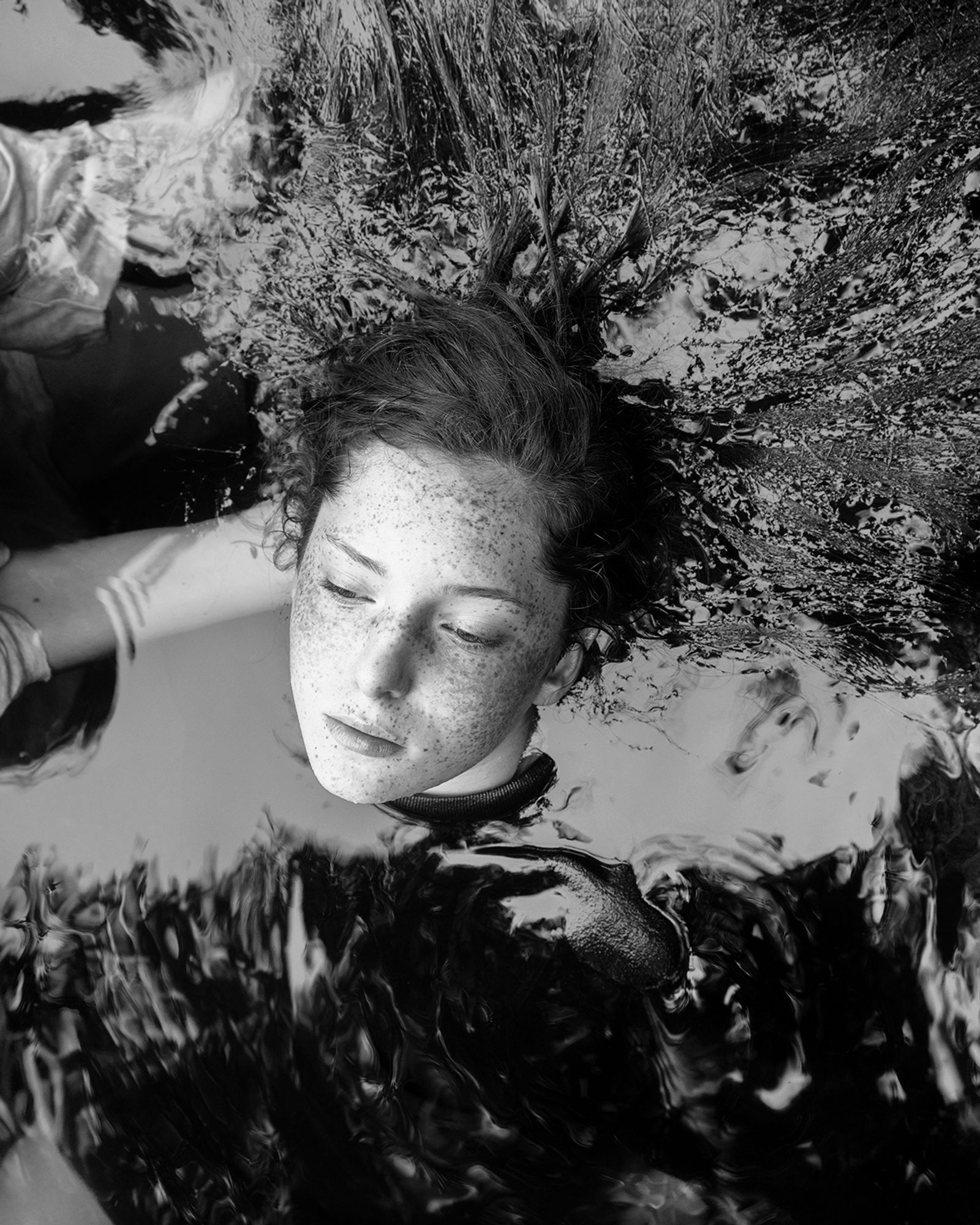 © Jillian Freyer - Elizabeth is held in the river just above the surface, by her sister Sadie.