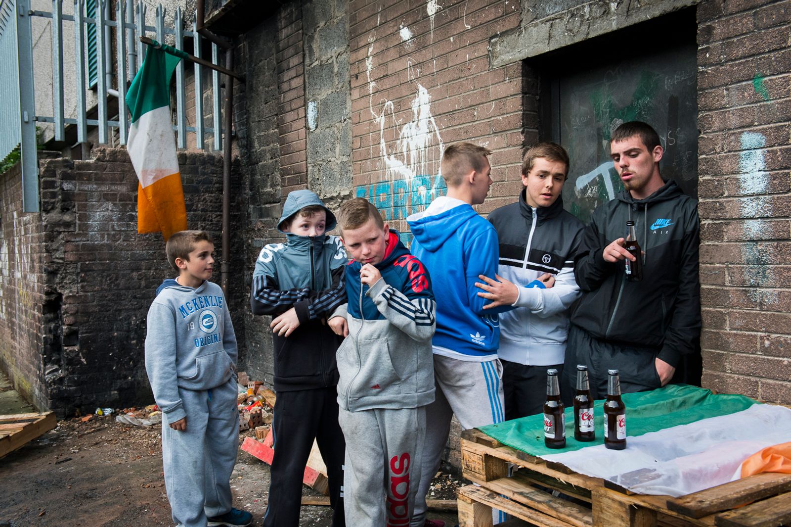 © Marika Dee - Surrounded by Irish flags, teenagers hang out in the Catholic New Lodge area of north Belfast.