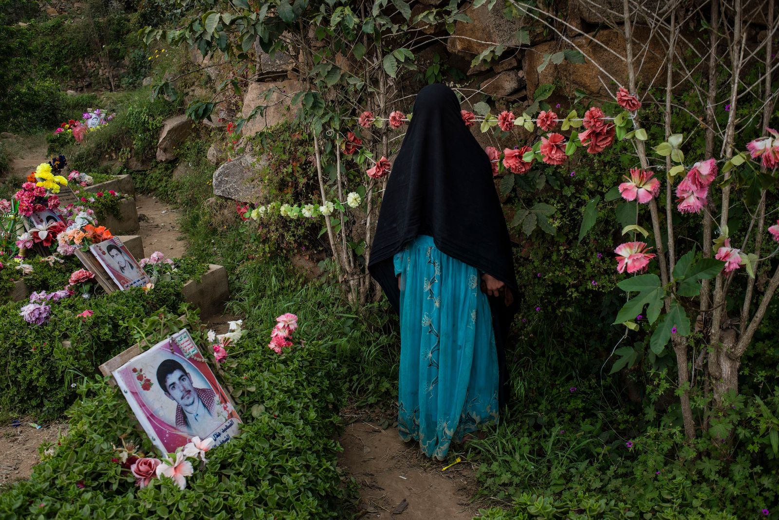 © Alex Potter - A girl visits the graves of Houthi martyrs killed in previous wars against them.
