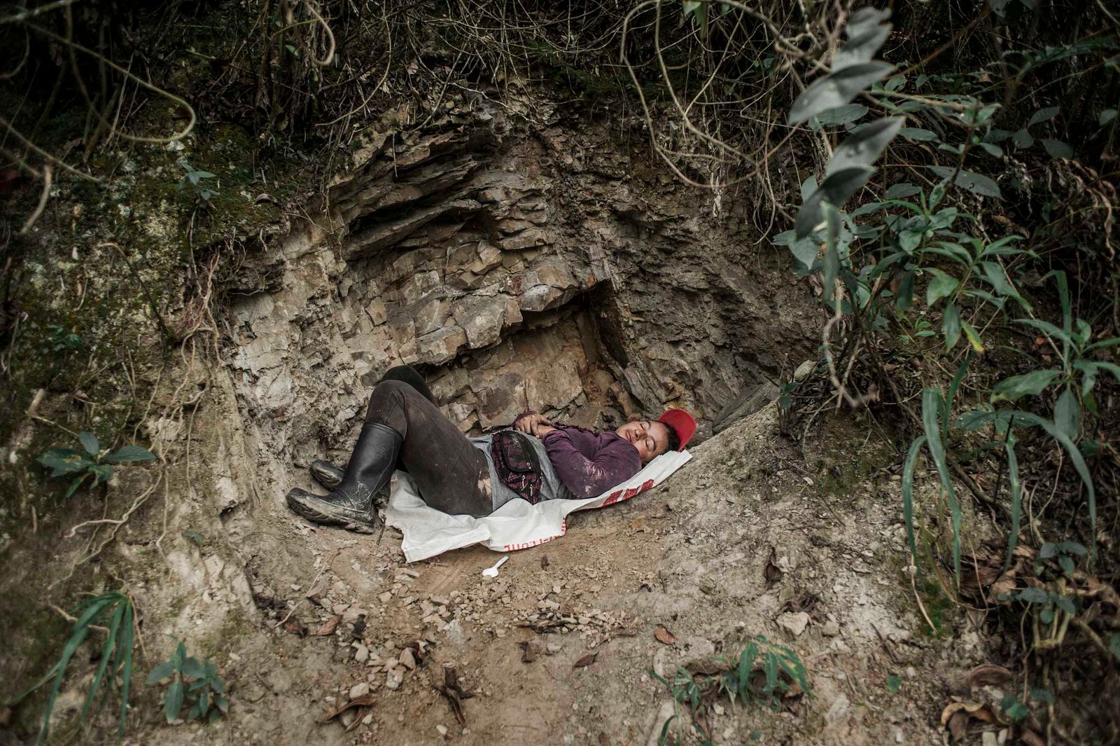 © Javier Corso - A female barequera rests after having traveled several miles from her house in search of emeralds.