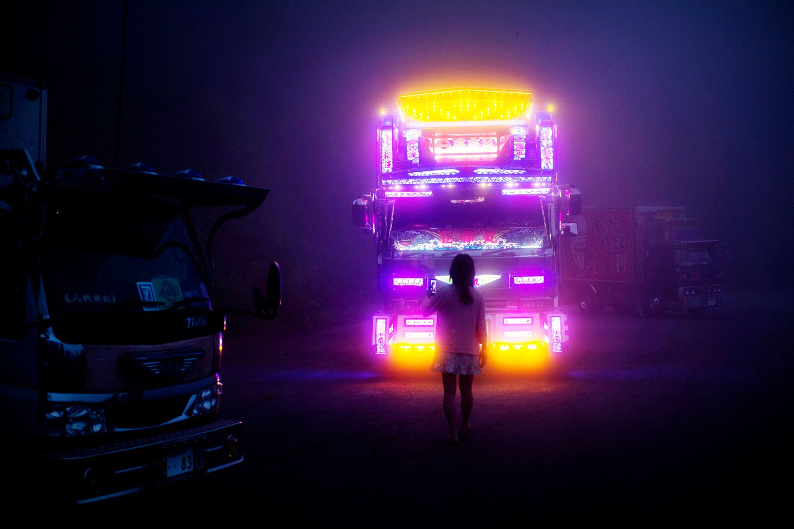 © Julie Glassberg - A girl standing in front of Ryujin Maru. Sendai Prefecture, in a foggy mountain area close to the city of Fukushima.