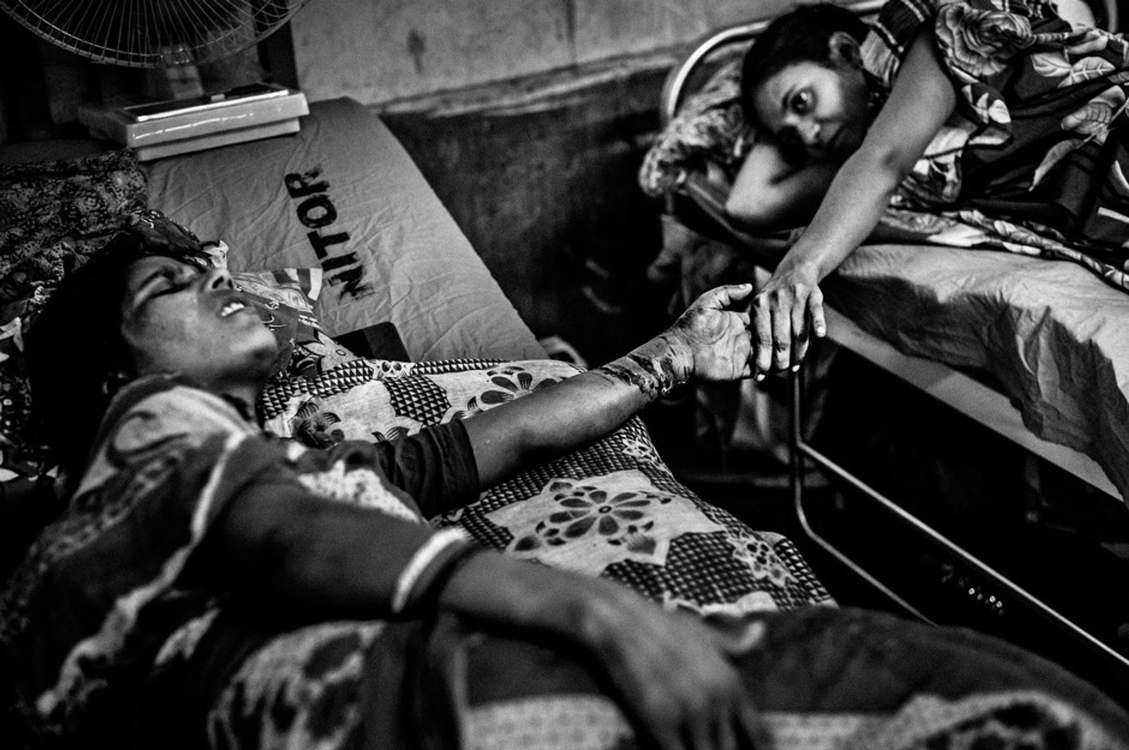 © Rahul Talukder - Two seriously injured victims comfort each other at the orthopedics and rehabilitation institute in Dhaka, Bangladesh.
