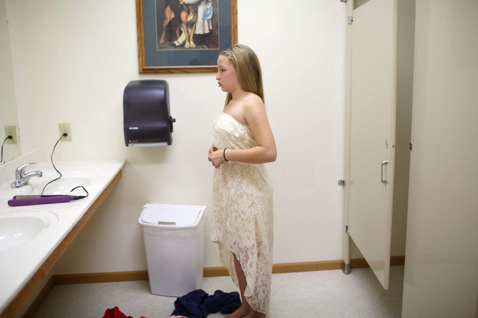 © Maddie Mcgarvey - Sonya, now 13, inspects herself in the mirror before her Aunt's wedding.