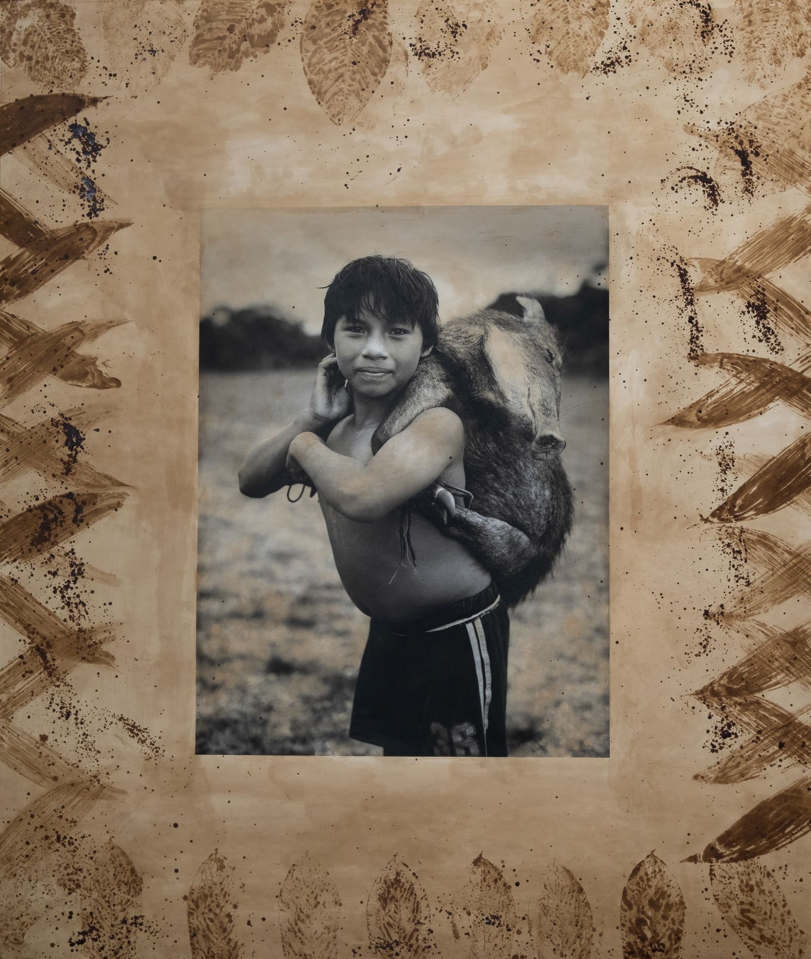 © Felipe Jacome - A young Waorani boy from the community of Bameno carries a wild boar during an afternoon of hunting.