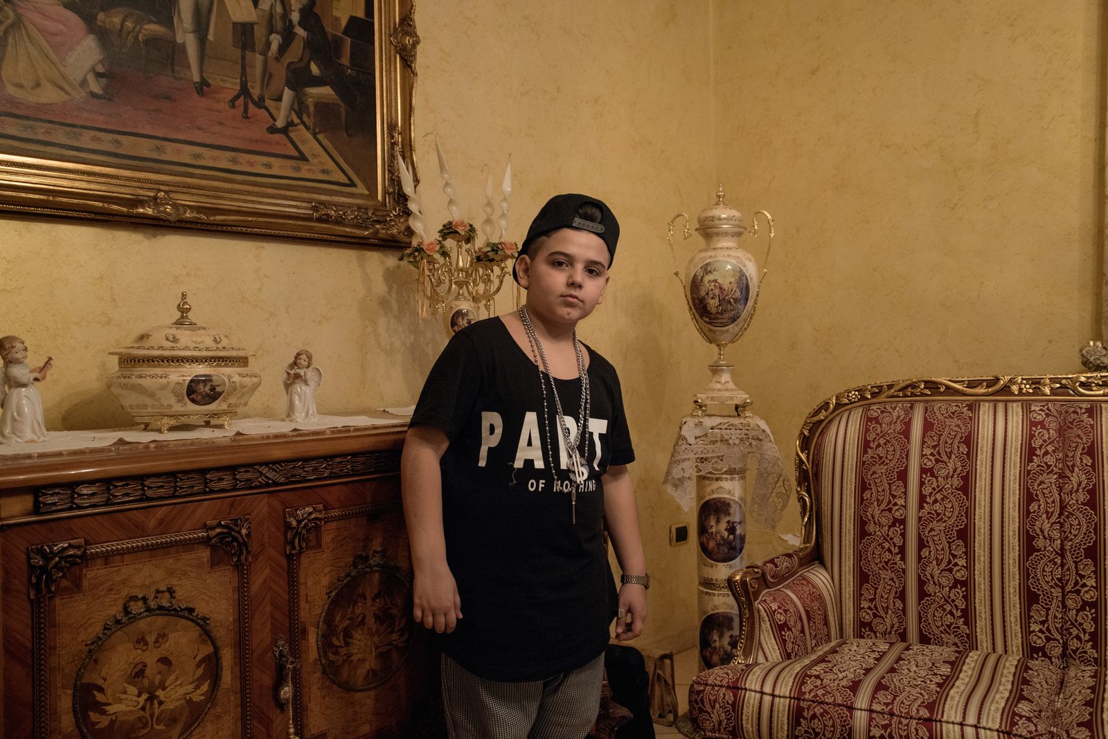 © Camillo Pasquarelli - Luciano Ferrara, 8 years old, in the living room of his house in Frignano.
