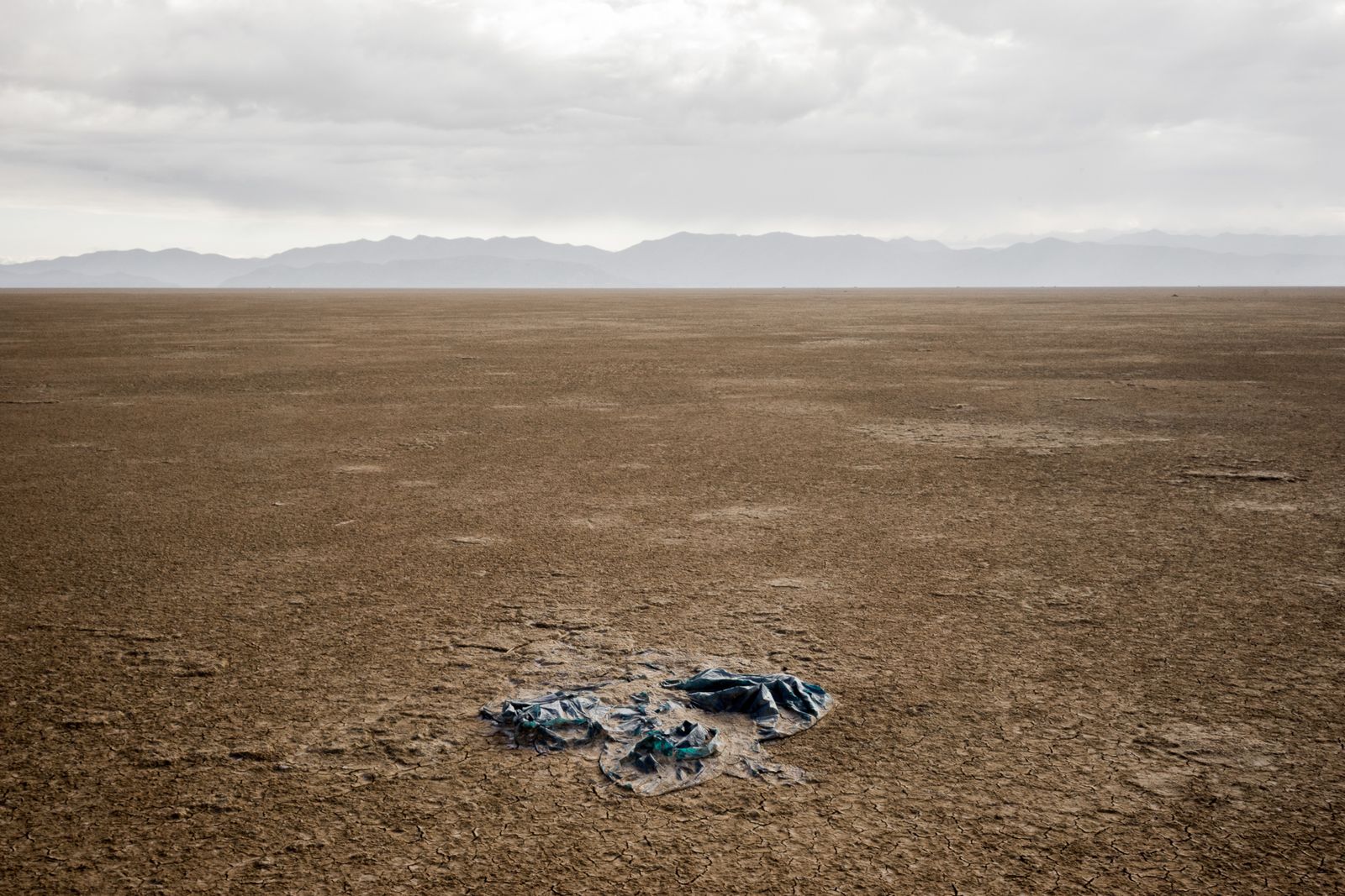 © Misha Vallejo - A piece of cloth merges with the soil of the now dried out Poopo lake in Bolivia.