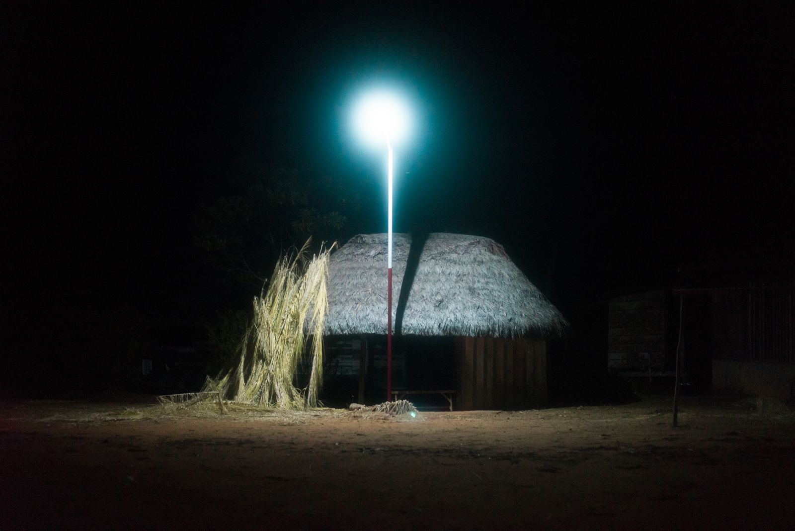 © Misha Vallejo - A hut is lit by solar powered lamps in Sarayaku’s central plaza.