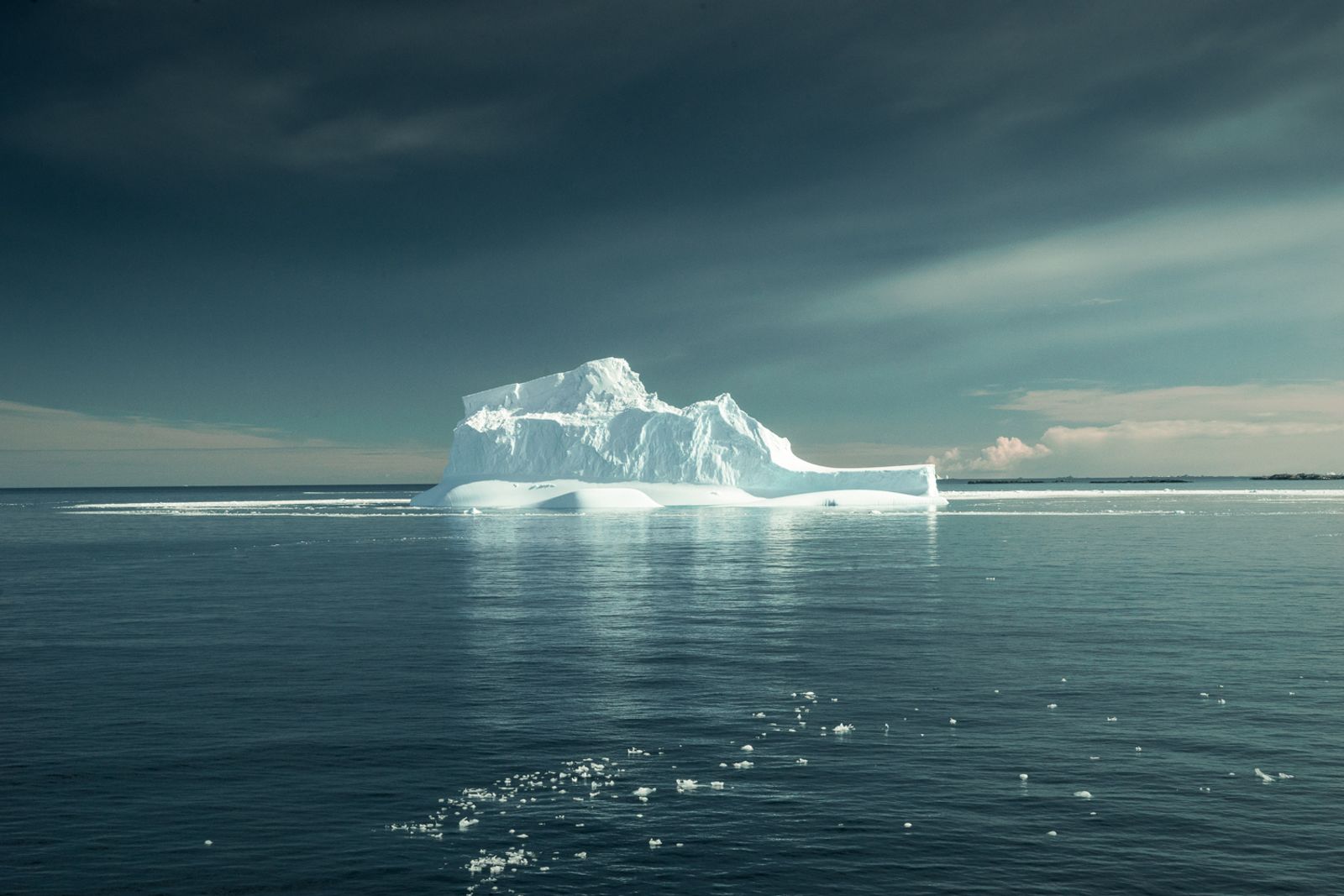© Isadora Romero - An iceberg several kilometers long floats in the then calm waters surrounding the Antarctic peninsula.