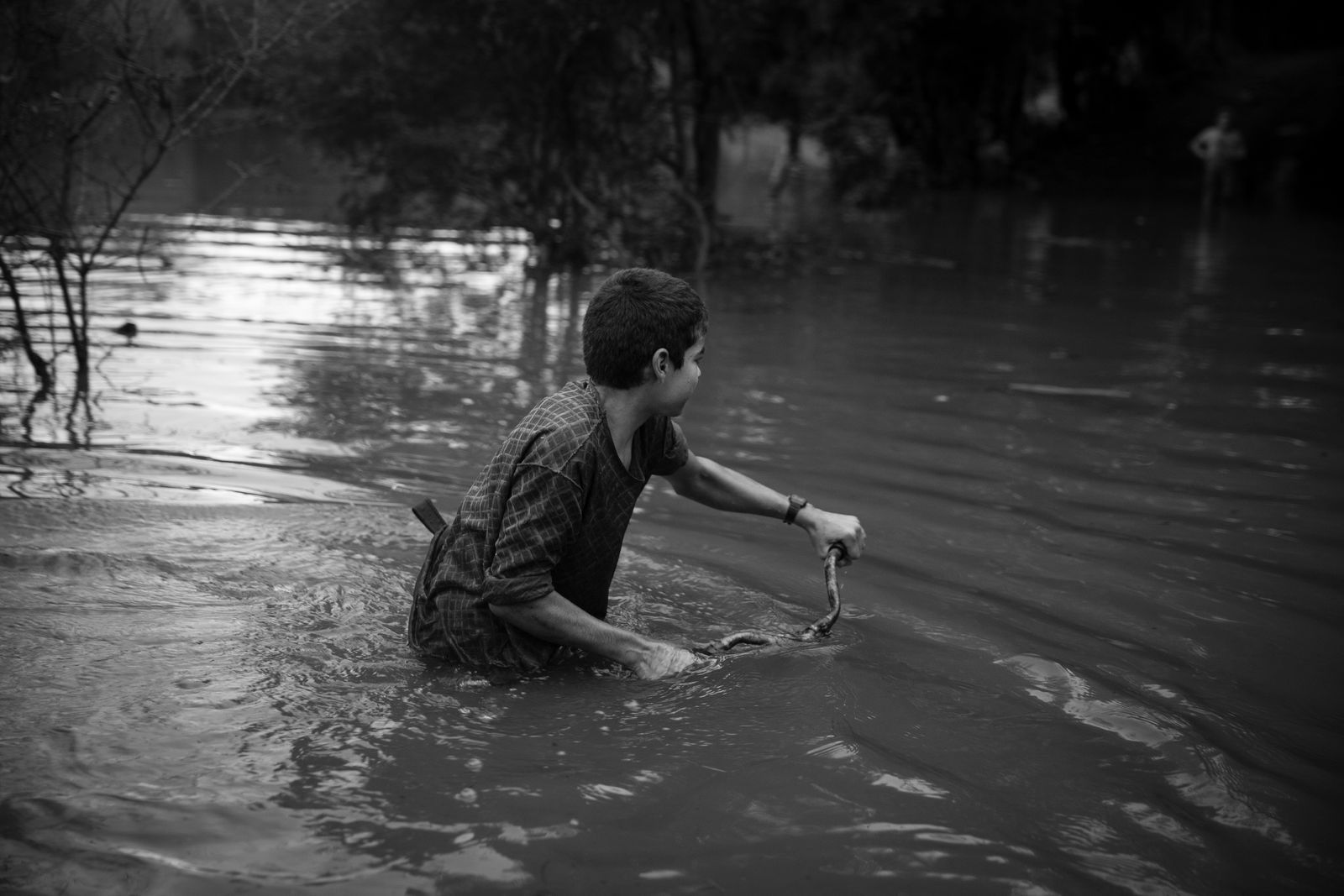 © Mercedes Cotoli - Leo with his faca (knife) biking across the stream.