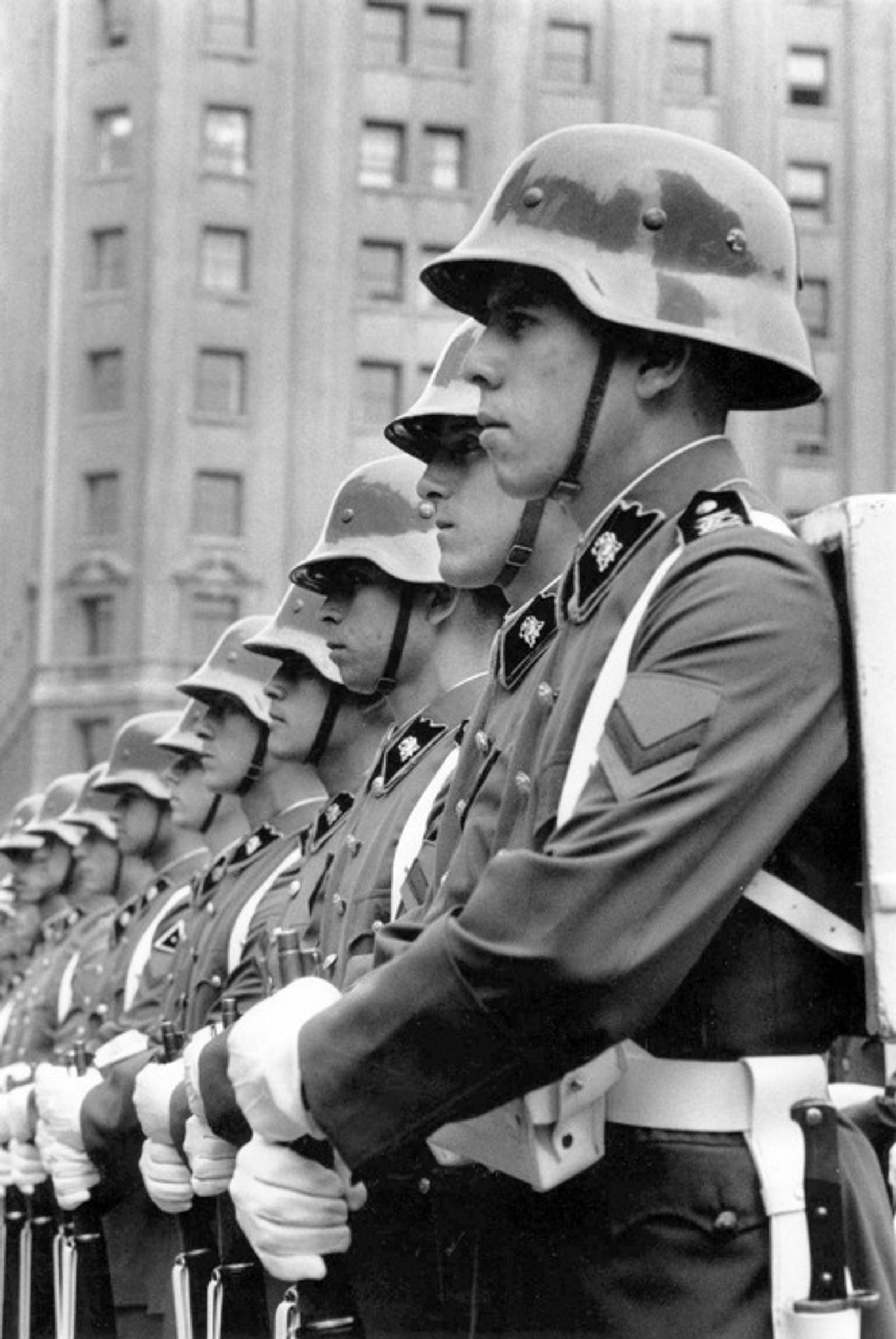 © Julio Etchart - Soldiers on parade displaying Nazi-style helmets during the Pinochet era