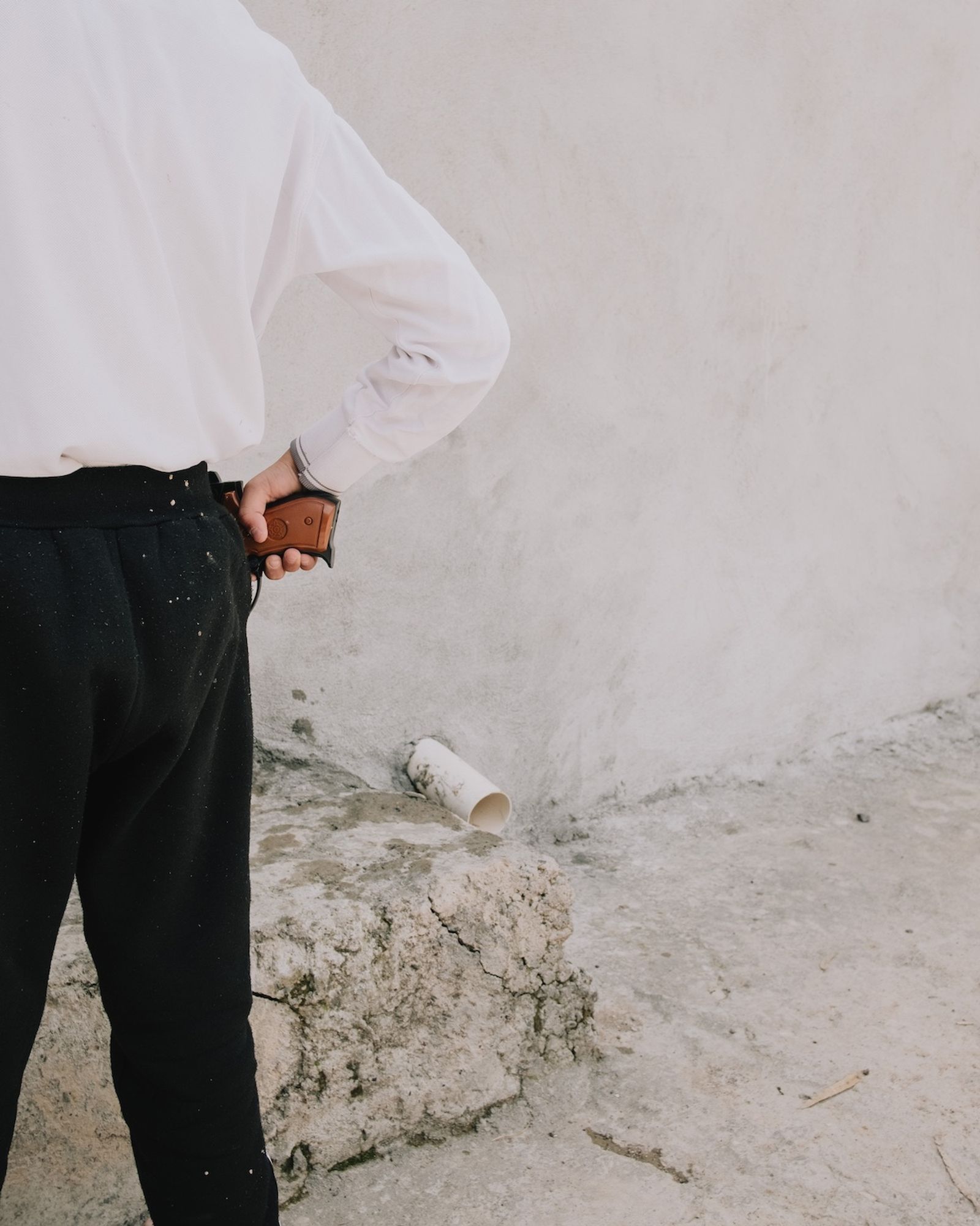 © Alexandra Howland - A boy plays with a plastic toy handgun in Karemles.