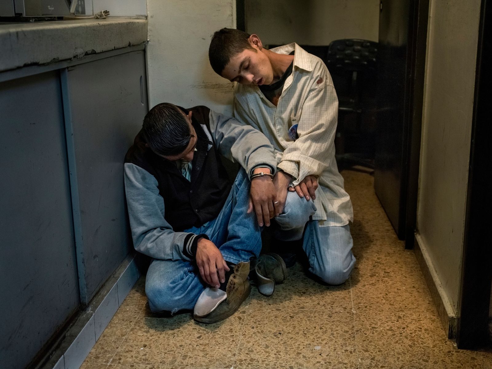 © Mads Nissen - Two young boys on drugs -completely out of reach- are being arrested by the police after some street fighting.