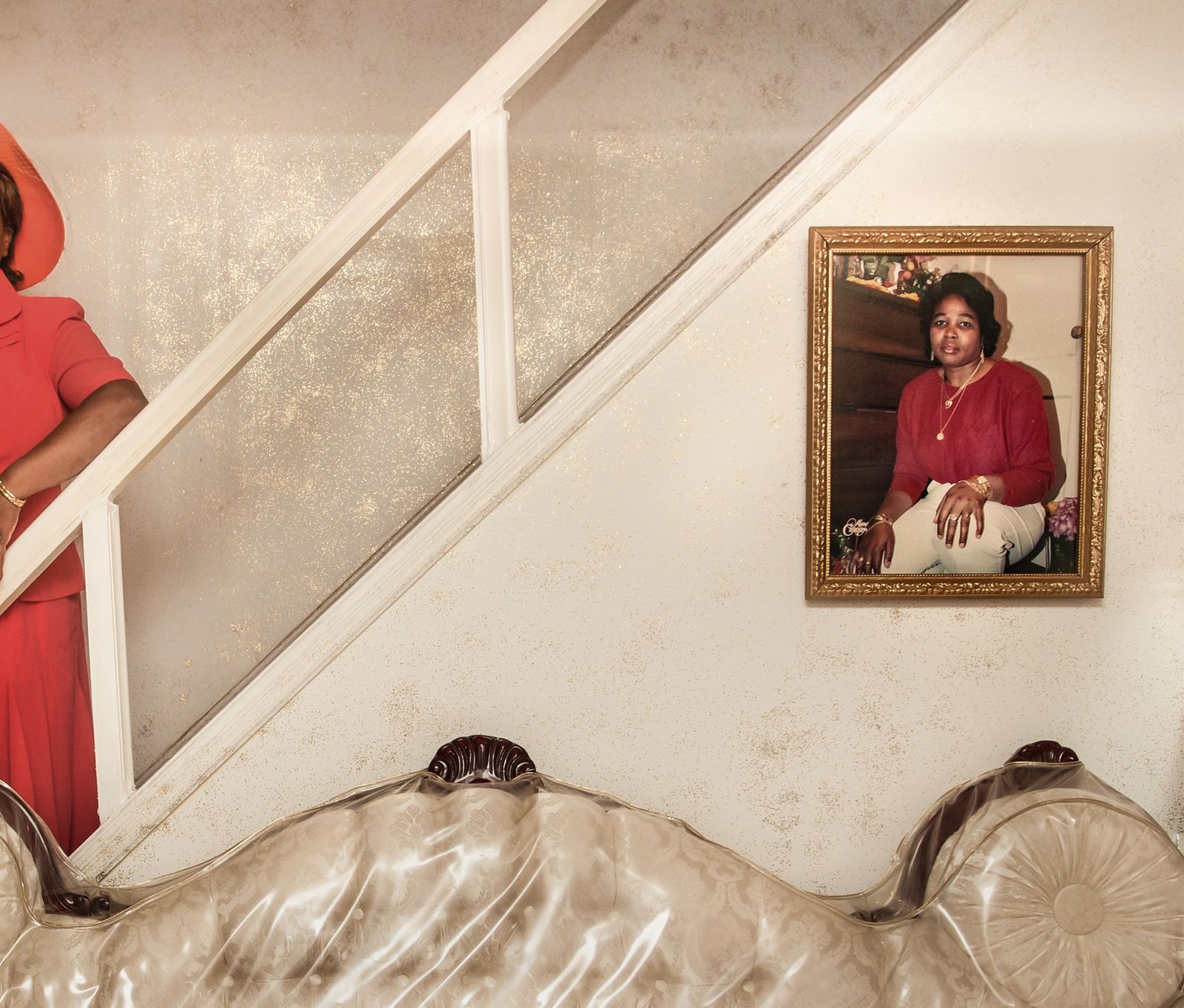 © Naomieh Jovin - Portrait of my godmother after church. She is standing next to a photo of her younger self.