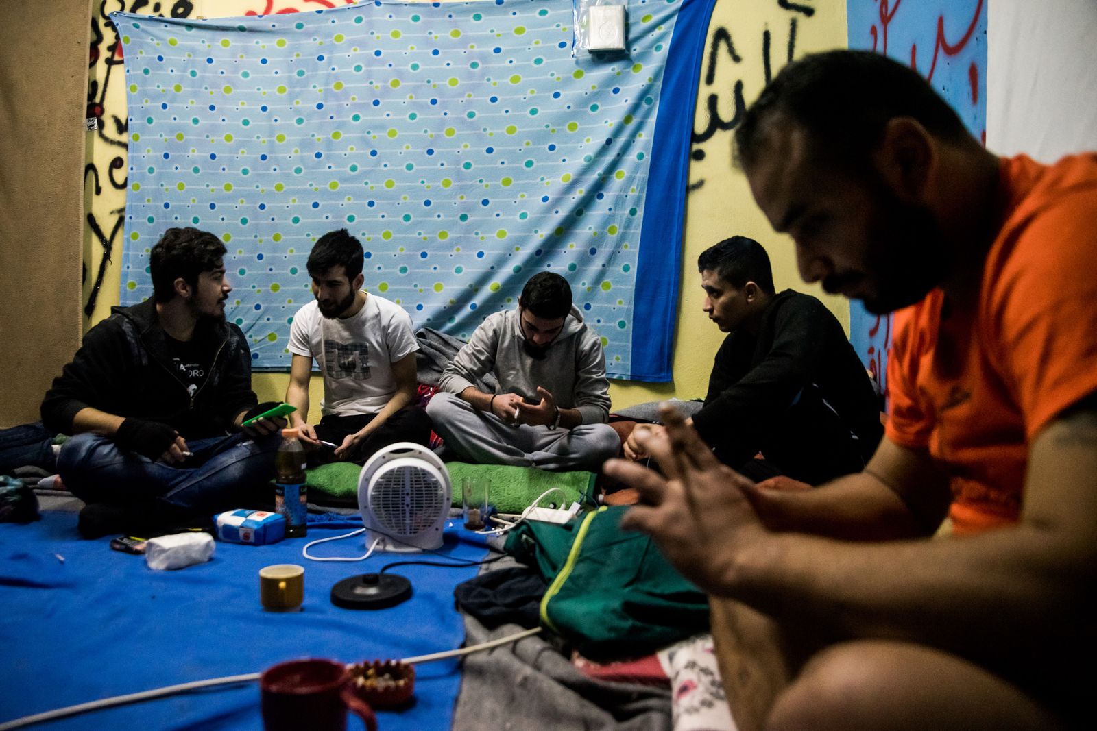 © Zoltán Balogh - Refugee men chat in a squat home named 2nd School in Athens, Greece, 05 December 2016.