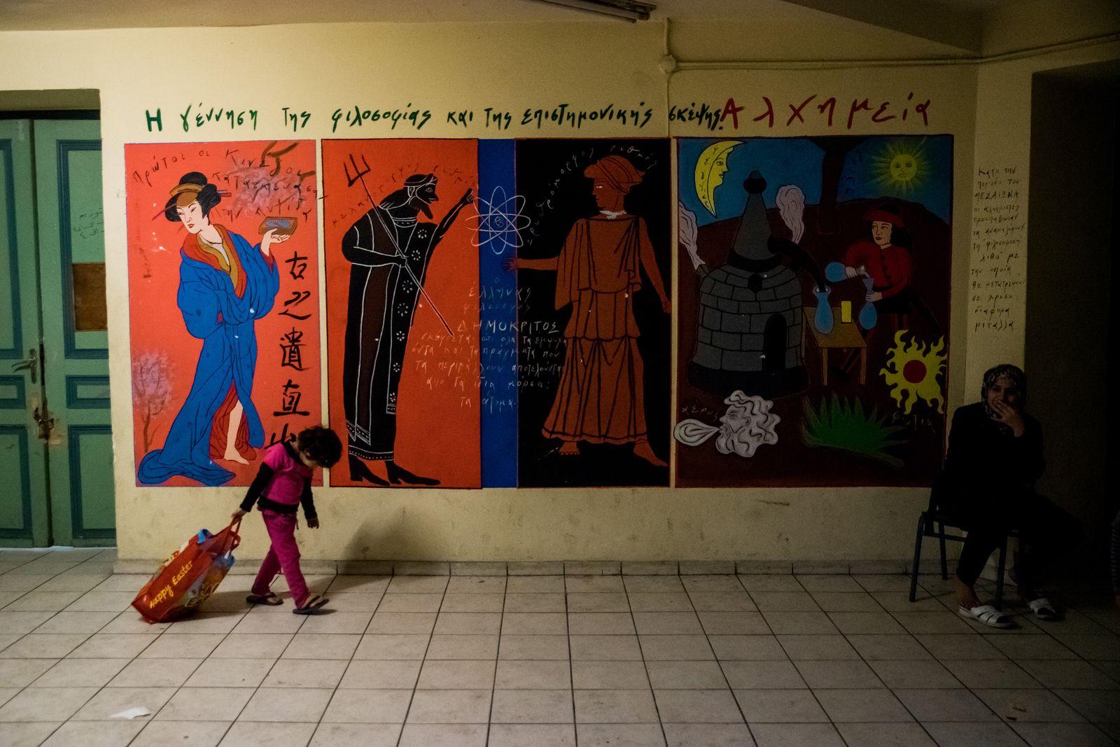 © Zoltán Balogh - A refugee child and a woman in a squat home named 2nd School in Athens, Greece, 05 December 2016.