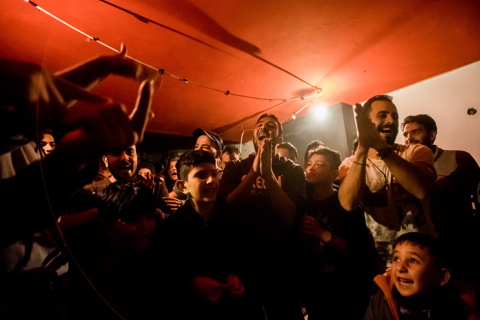 © Zoltán Balogh - Refugees singing and dancing on a wedding in a squat home named Spirou Trikoupi 17 in Athens, Greece, 30 November 2016.