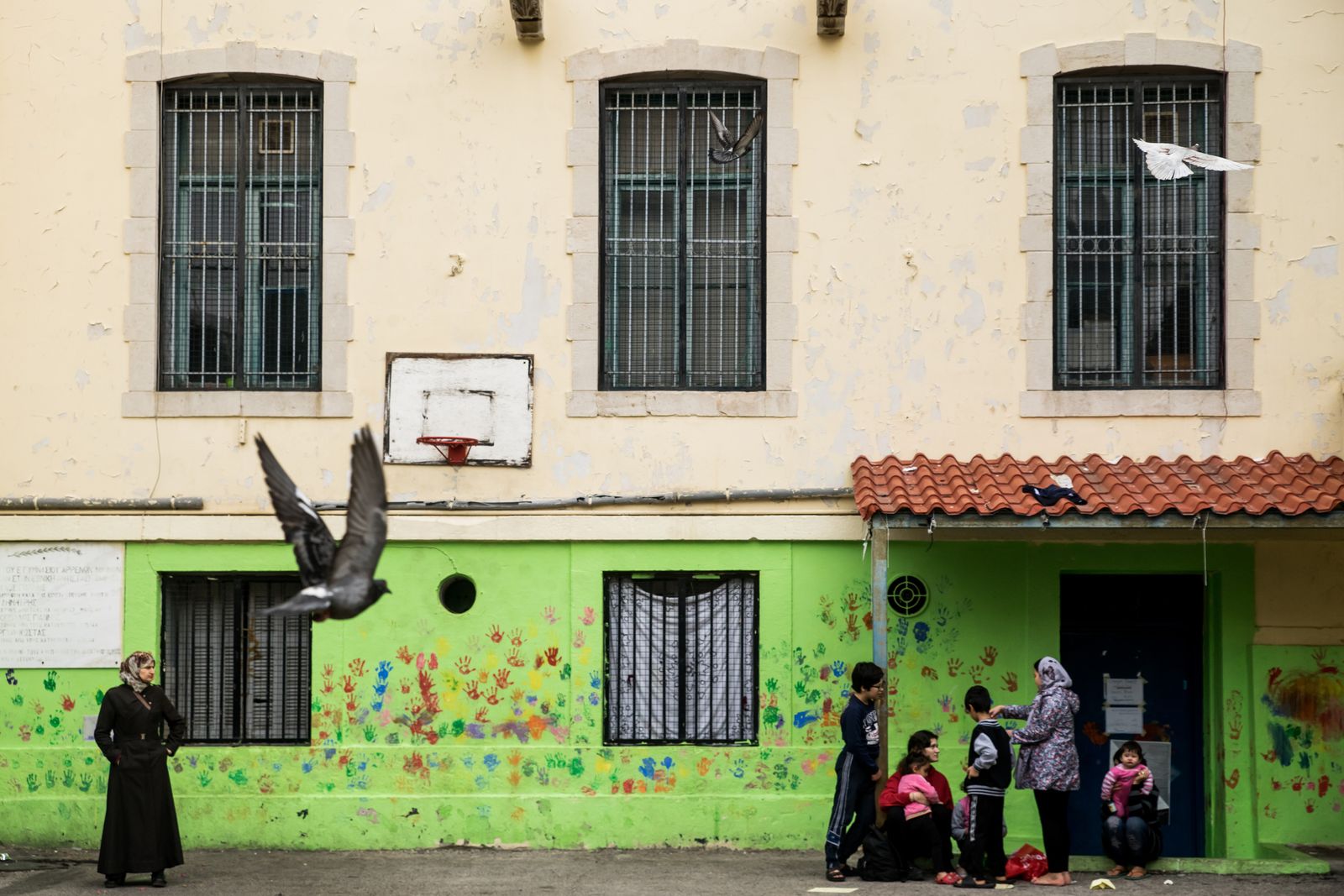 © Zoltán Balogh - Refugees are pictured near the entrance of a squat home named 5th School in Athens, Greece, 04 December 2016.