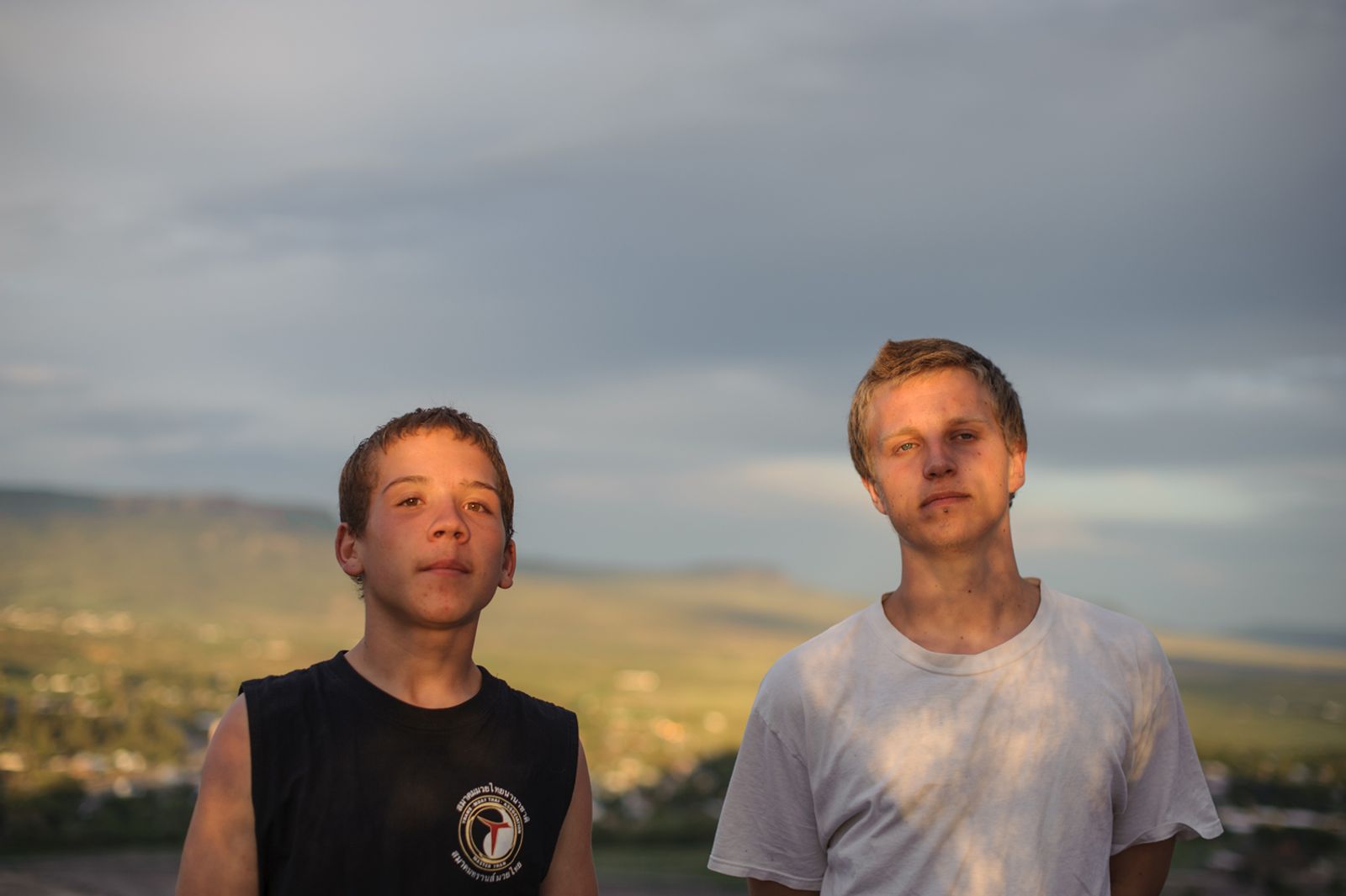 © Isadora Kosofsky - Brothers Vinny and David stand together as the sky darkens before a summer storm.