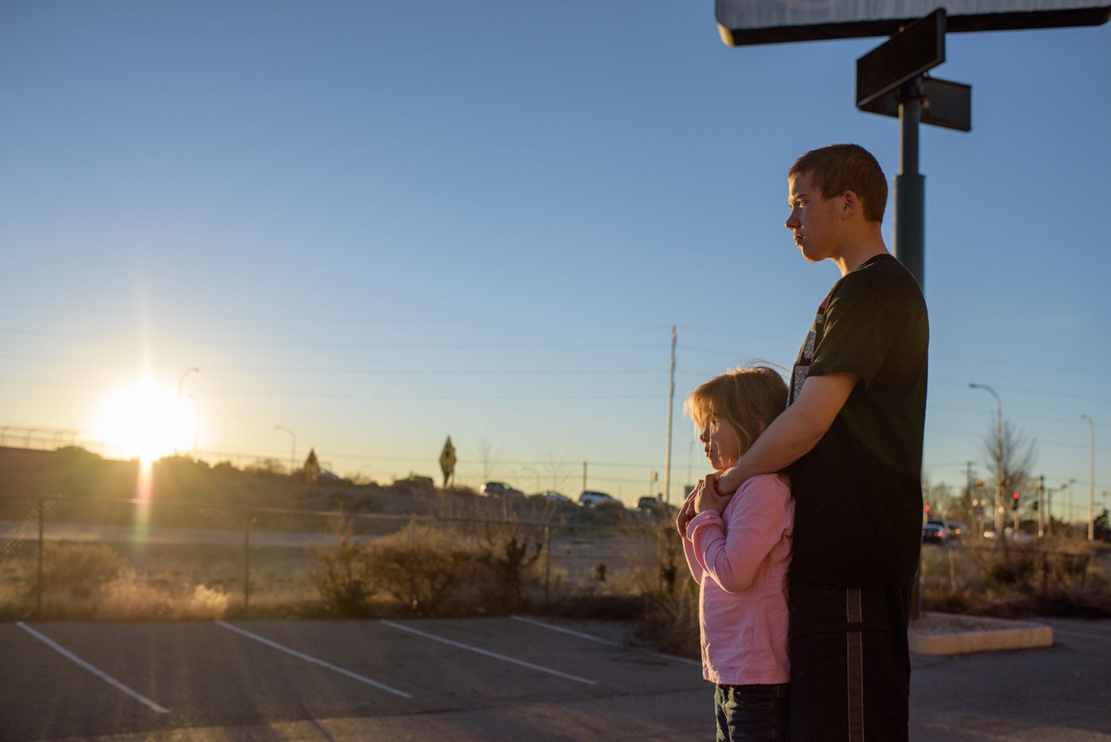 © Isadora Kosofsky - Vinny and his sister, Elycia, watch the sun set behind Highway-40 or Route 66.