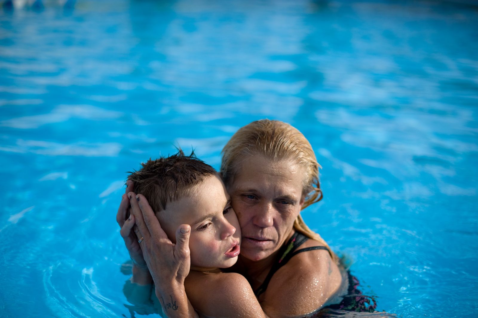 © Isadora Kosofsky - Eve holds Michael in the pool. Michael’s greatest wish is to receive “ a hug. I want a hundred hugs a day.”