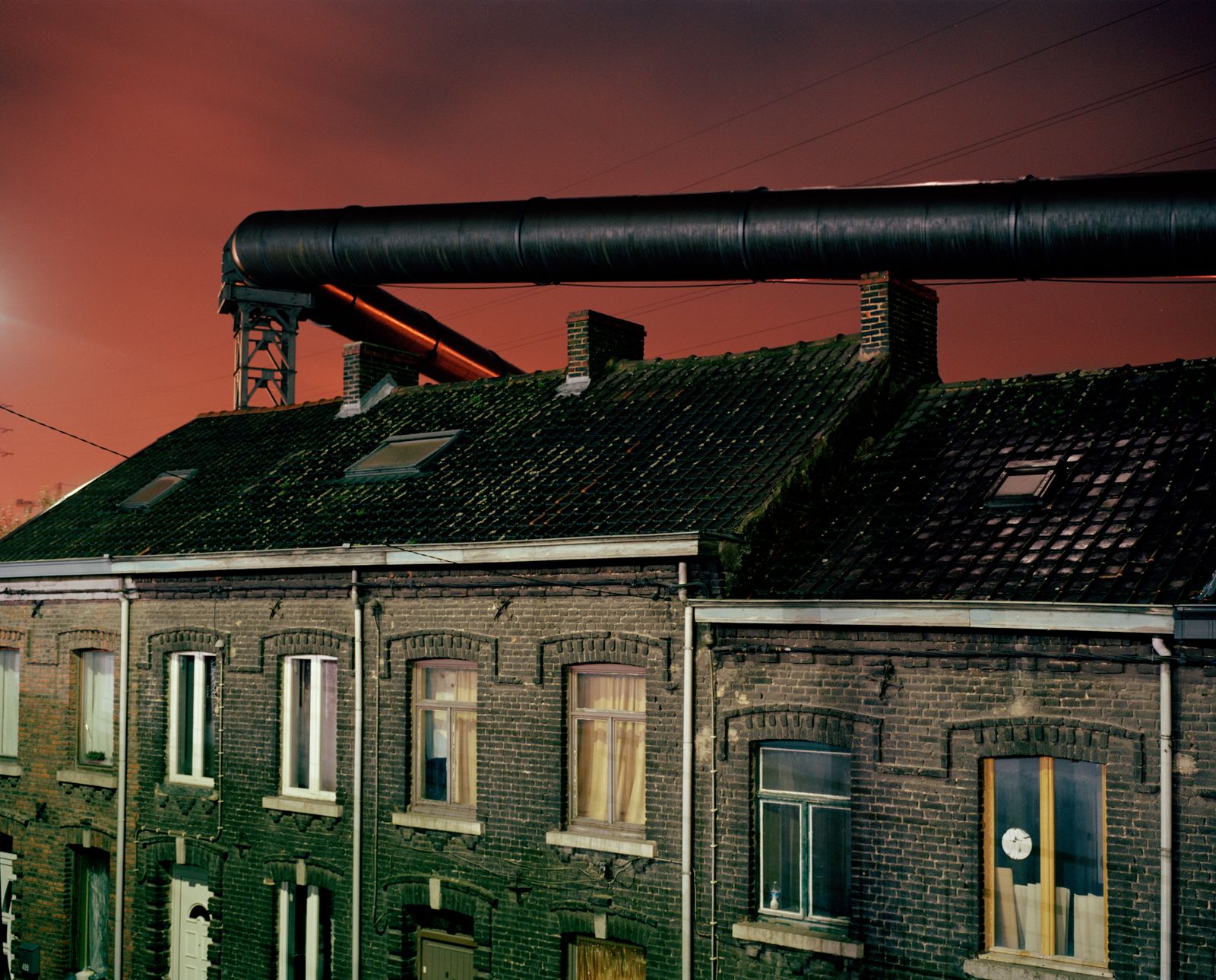 © Giovanni Troilo - The gas supply tubes run along the houses built near the steel factories of Charleroi.