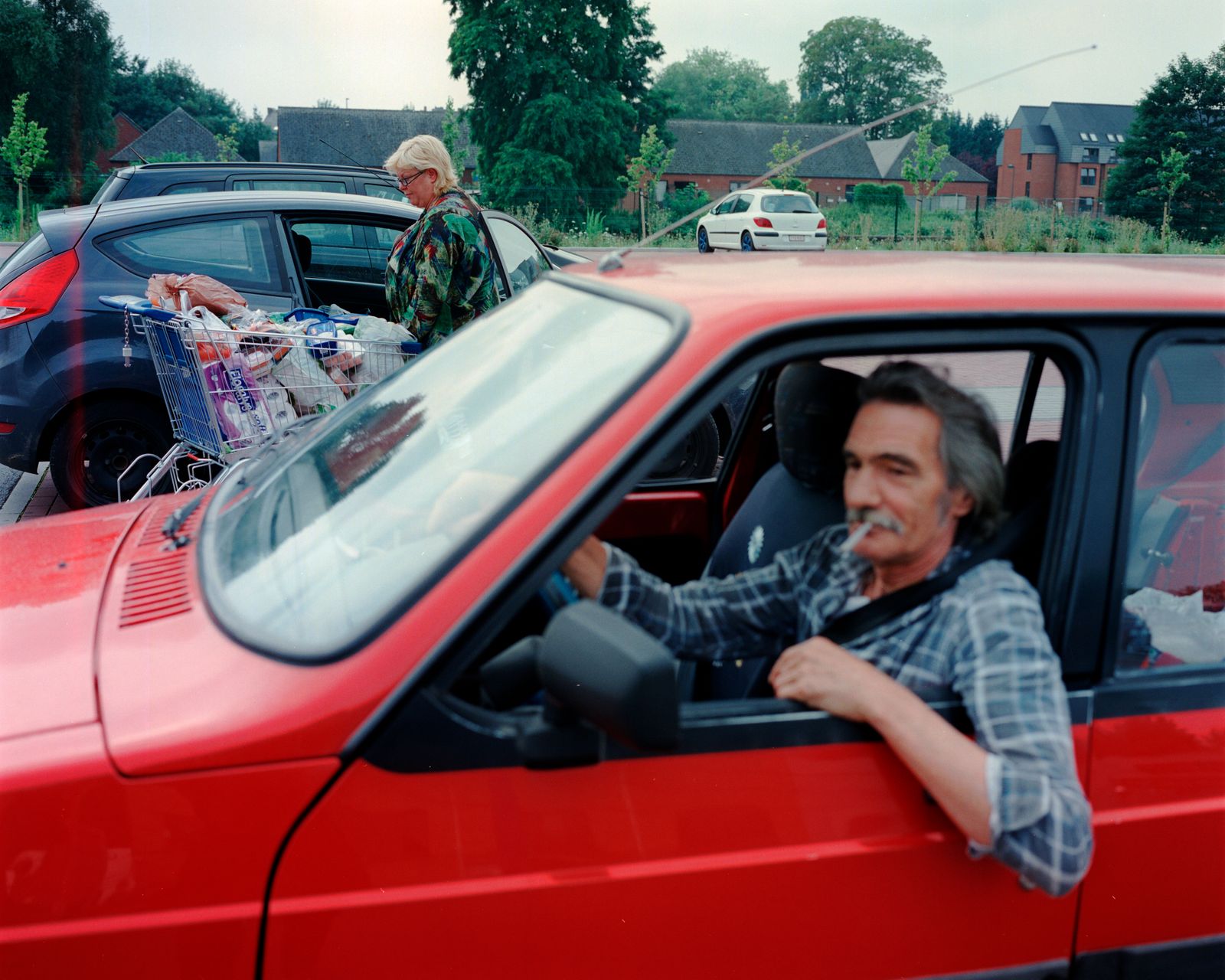 © Giovanni Troilo - A man waiting fot his wife outside the supermarket.