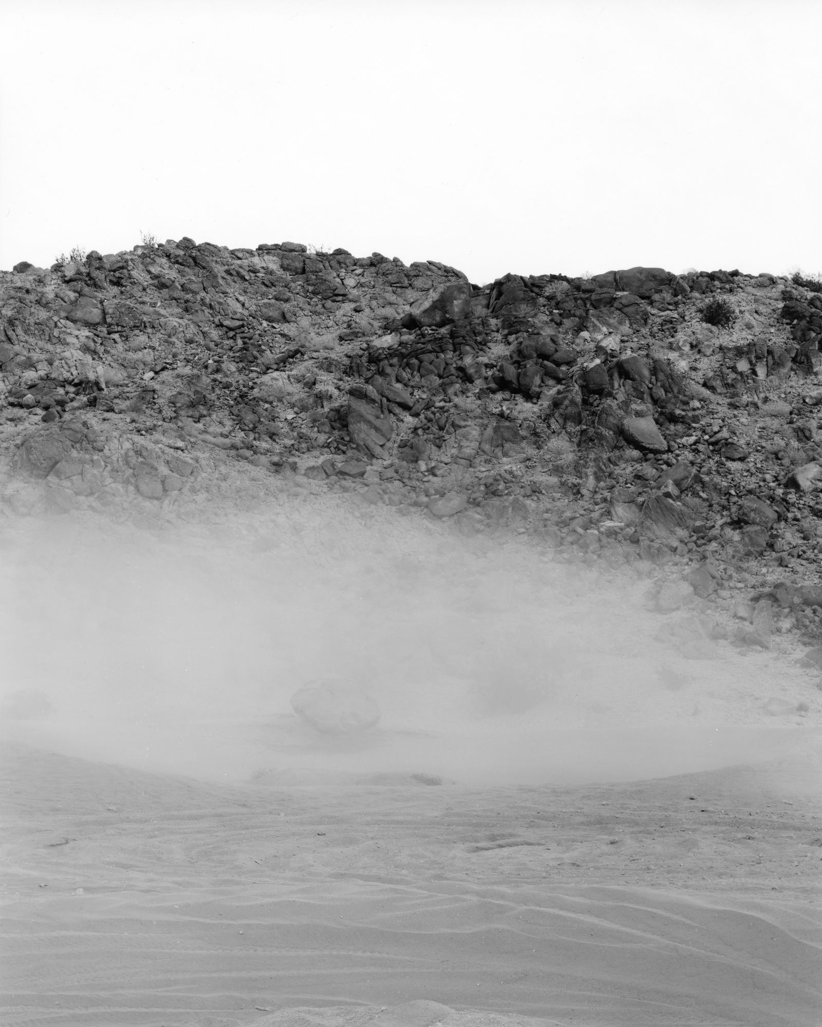 © Nicholas Albrecht - Dust emerging from crater-like hole.