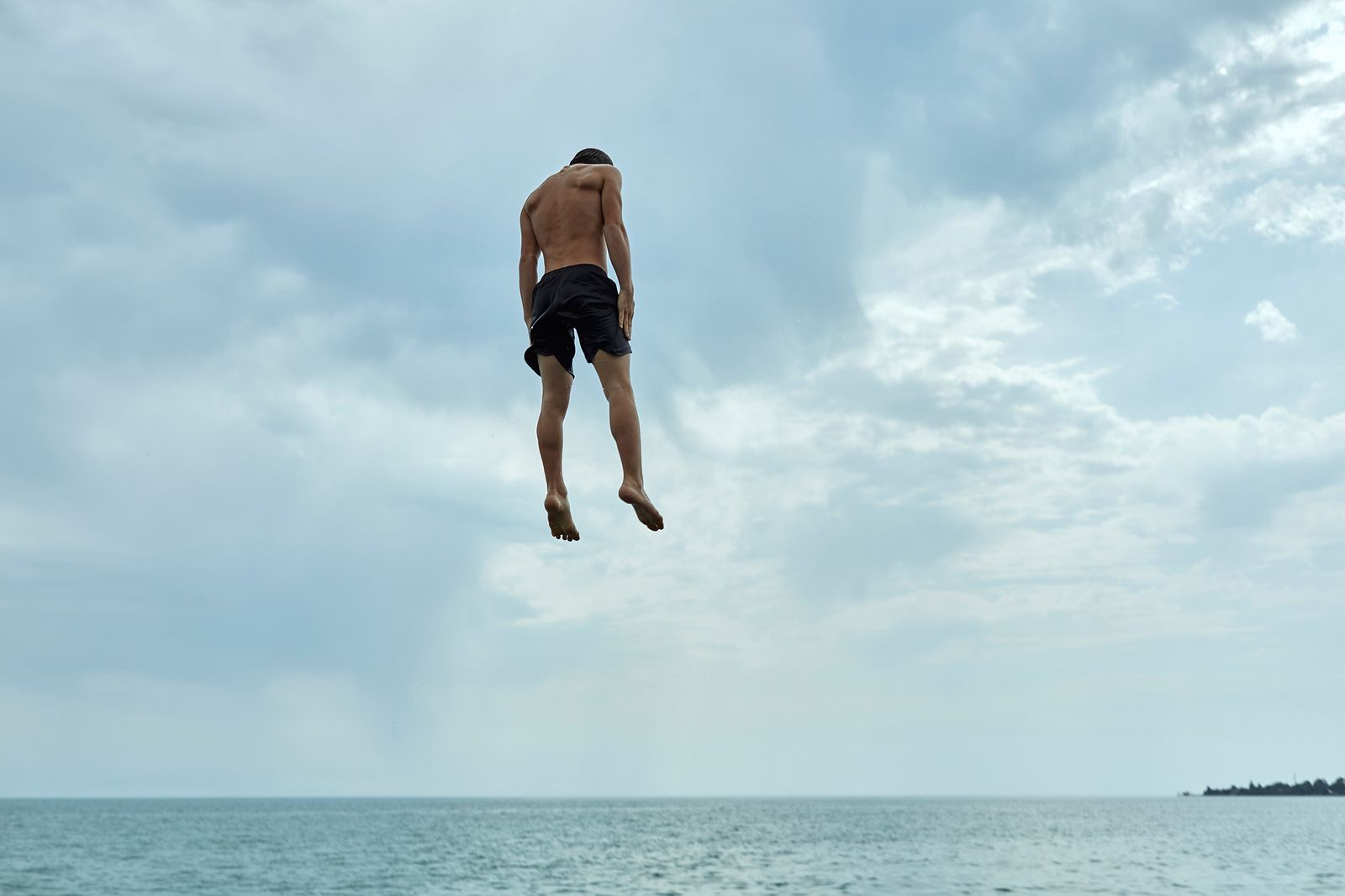 © Ksenia Kuleshova - Abkhazia, Sukhum, 04/07/2017. Children spend their free time on the beach. A boy is jumping into the water.