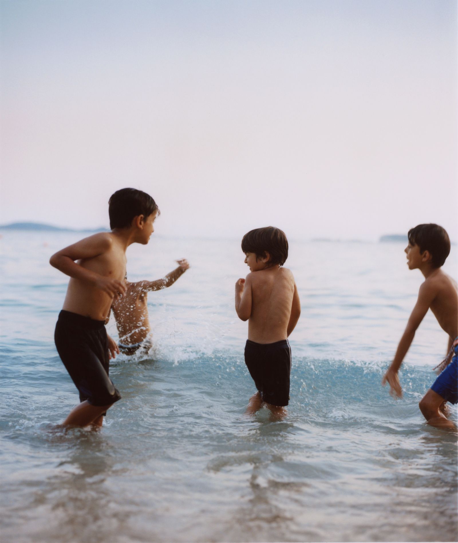 © Julia Marino - Children Playing in Ocean, 2019