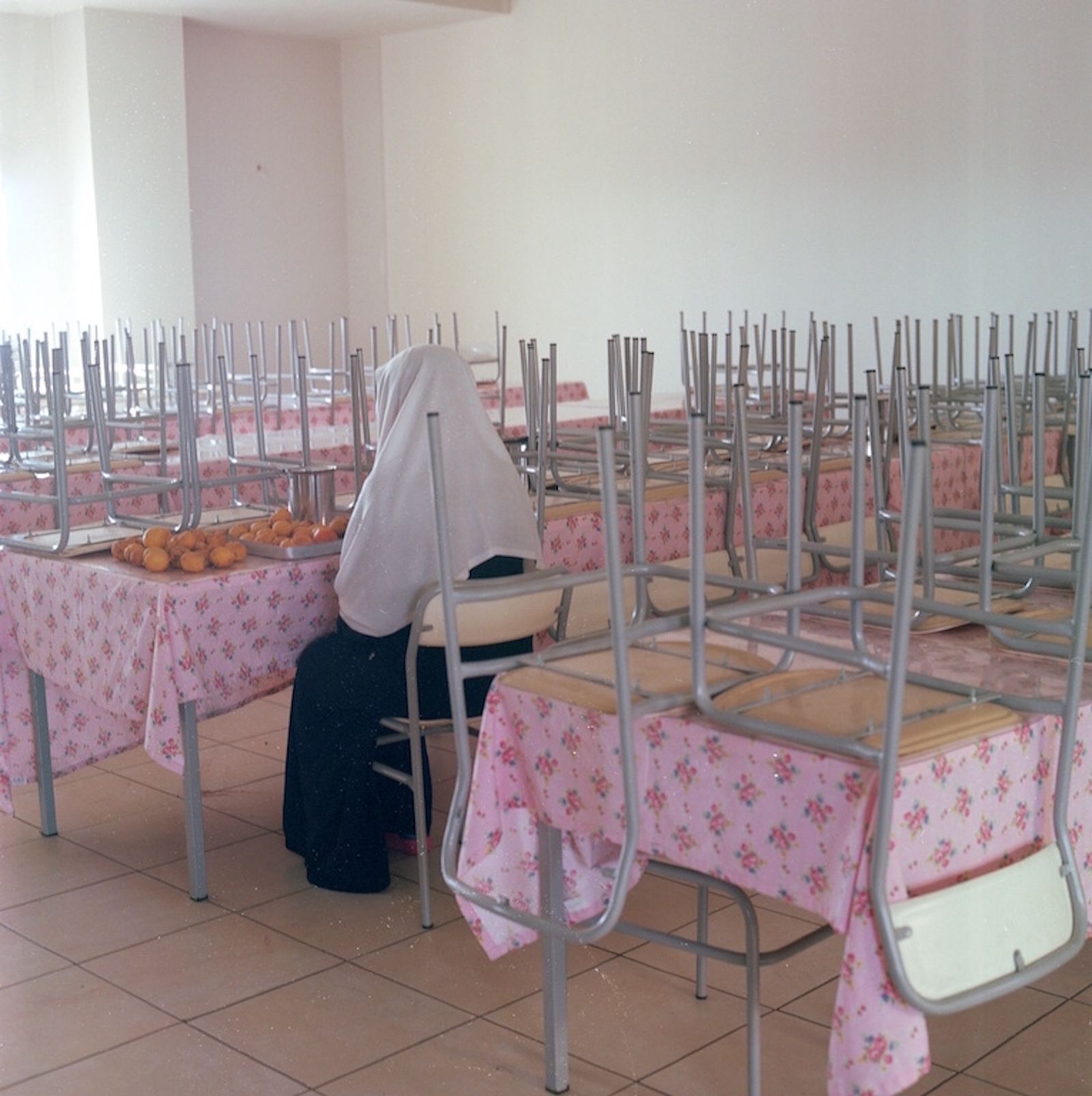 © Sabiha Çimen - Dining Room. Turkey-Kars A hall monitor girl sitting alone at the dining room, separating the moldy oranges.