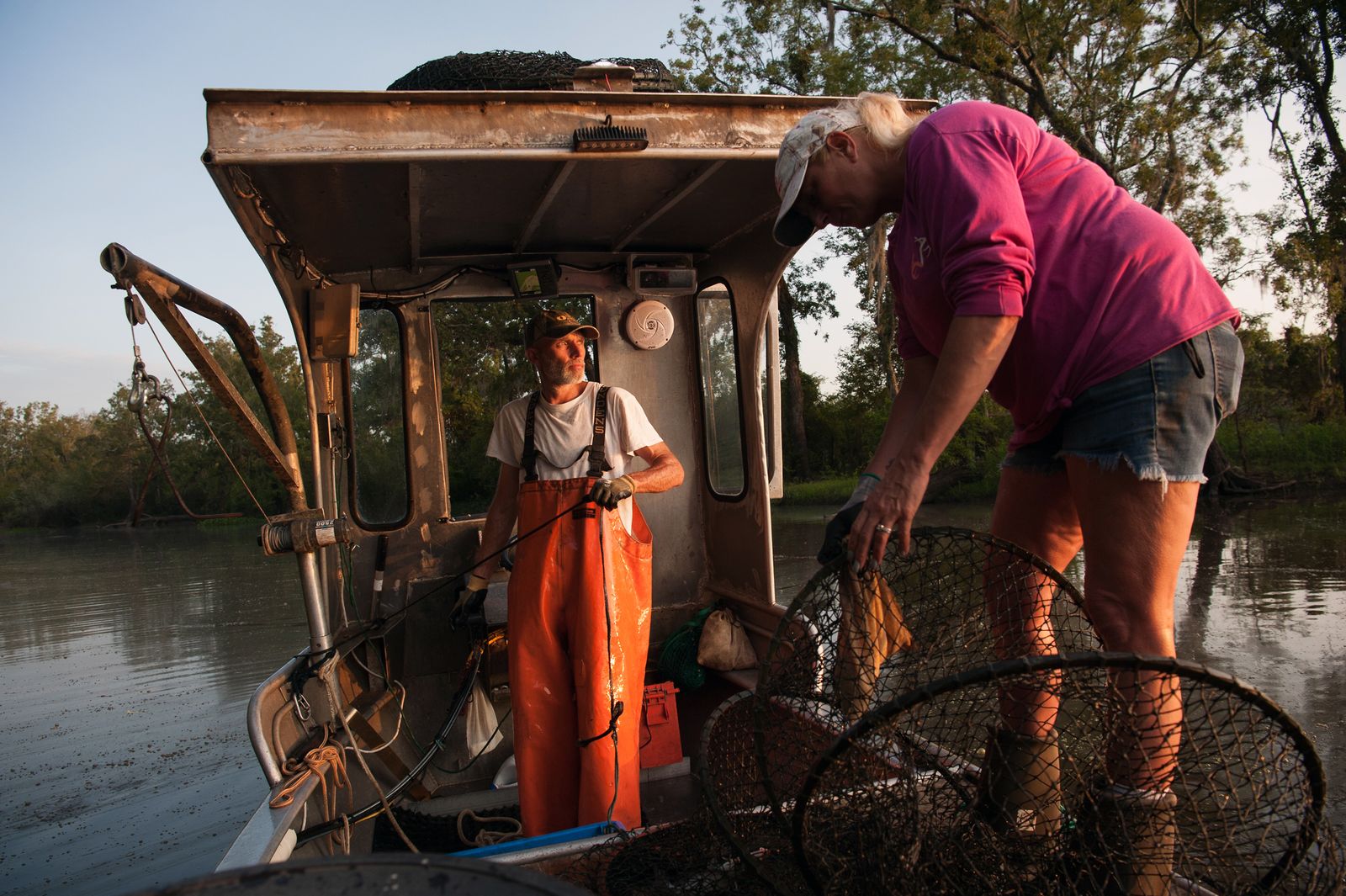 © Rory Doyle - Quentin (left) and Jamie Morales hoop net for catfish in Bayou Sorrel, Louisiana, USA.